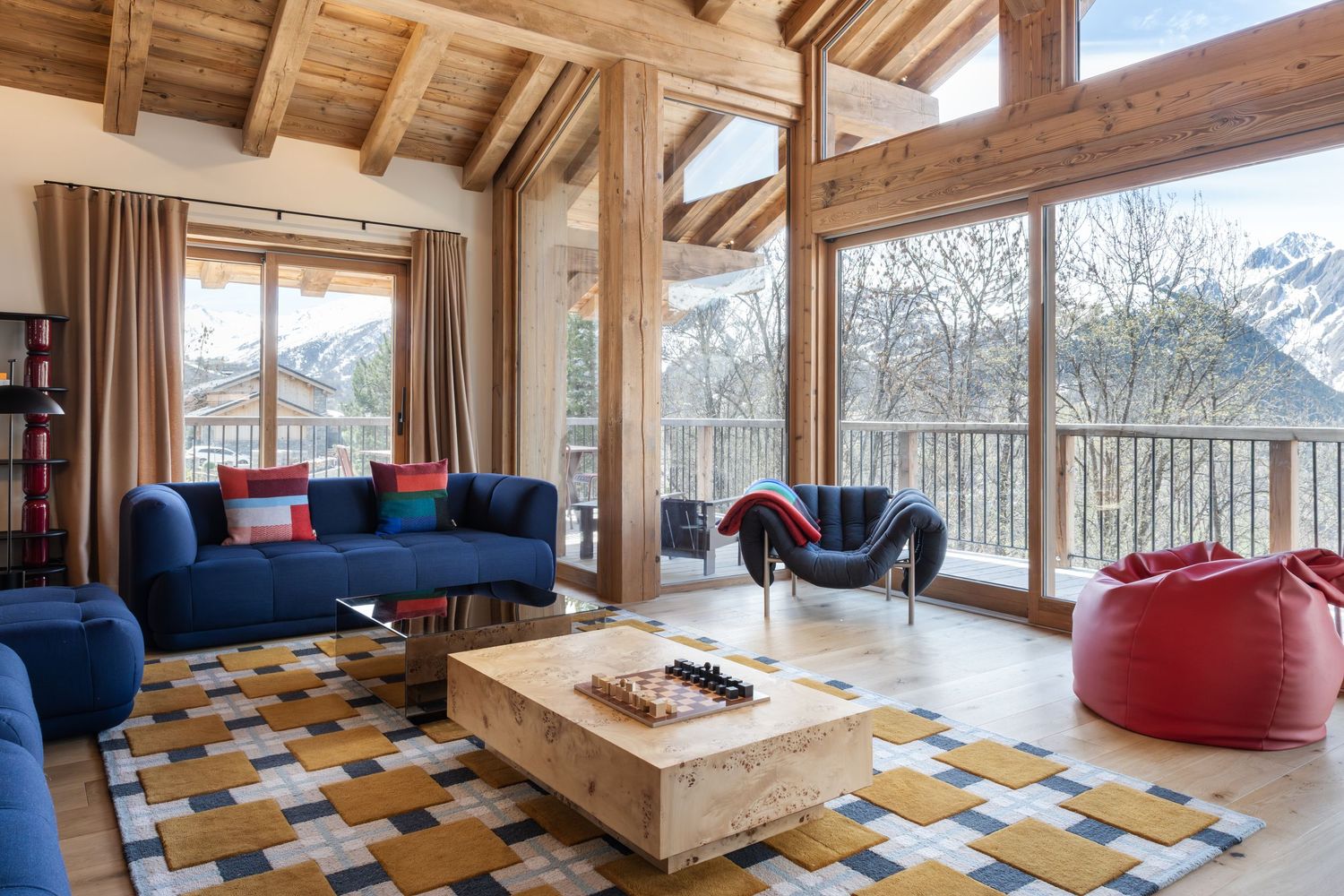 corner view of large living room with blue sofas and red beanbag