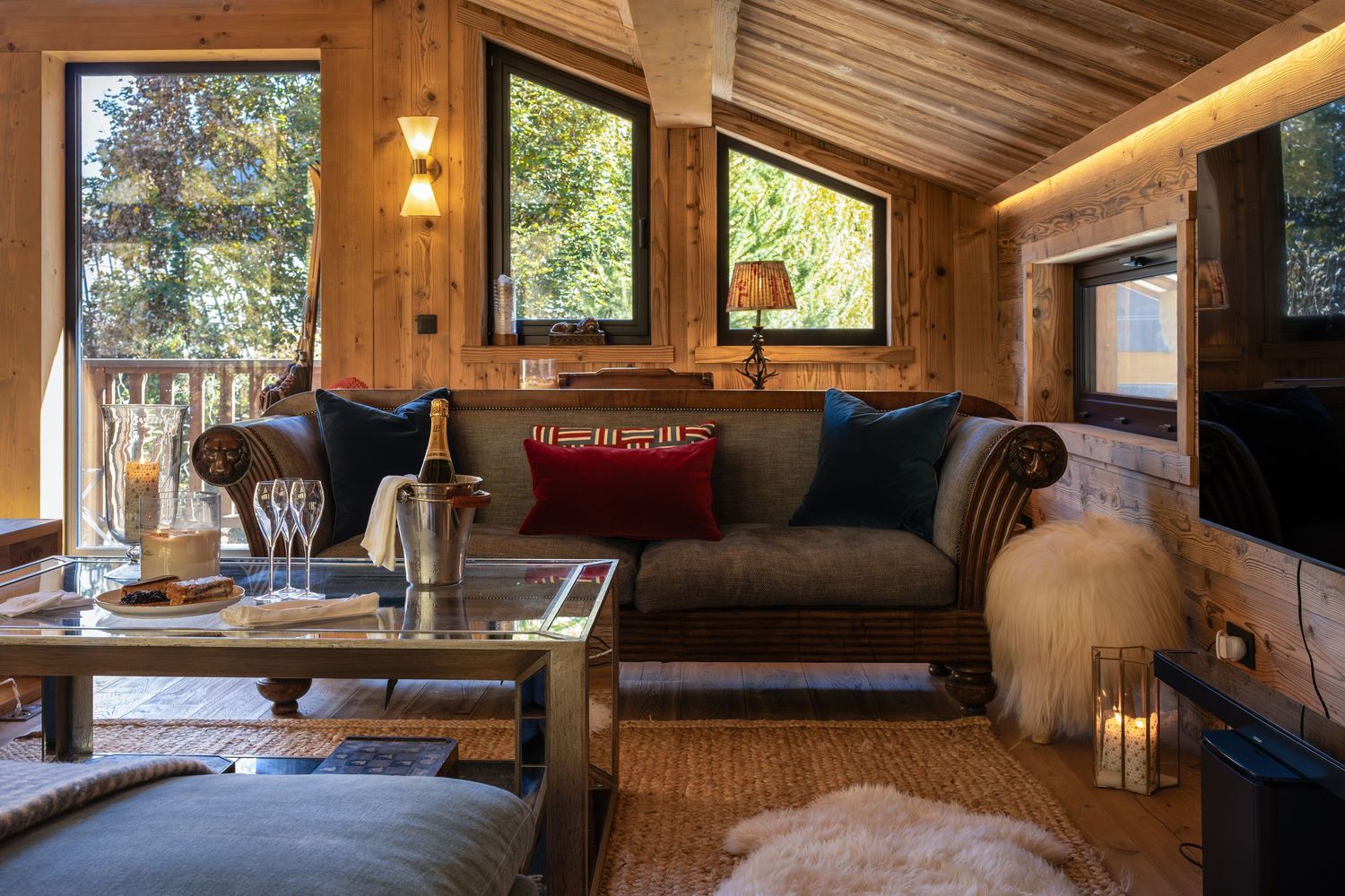 sofa with coffee table and champagne on ice in luxury ski chalet