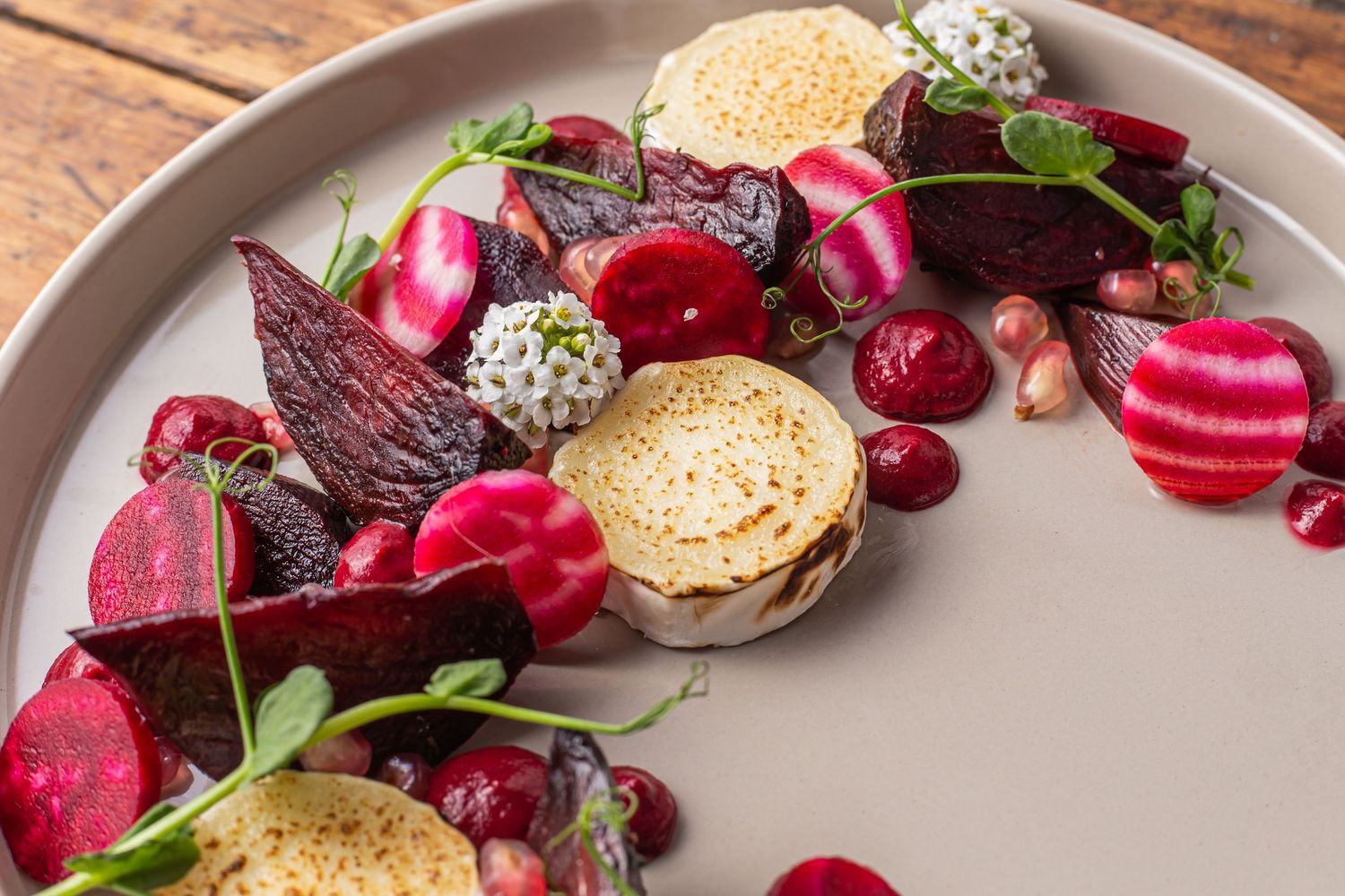 close up go beetroot salad and goats cheese on a beige plate