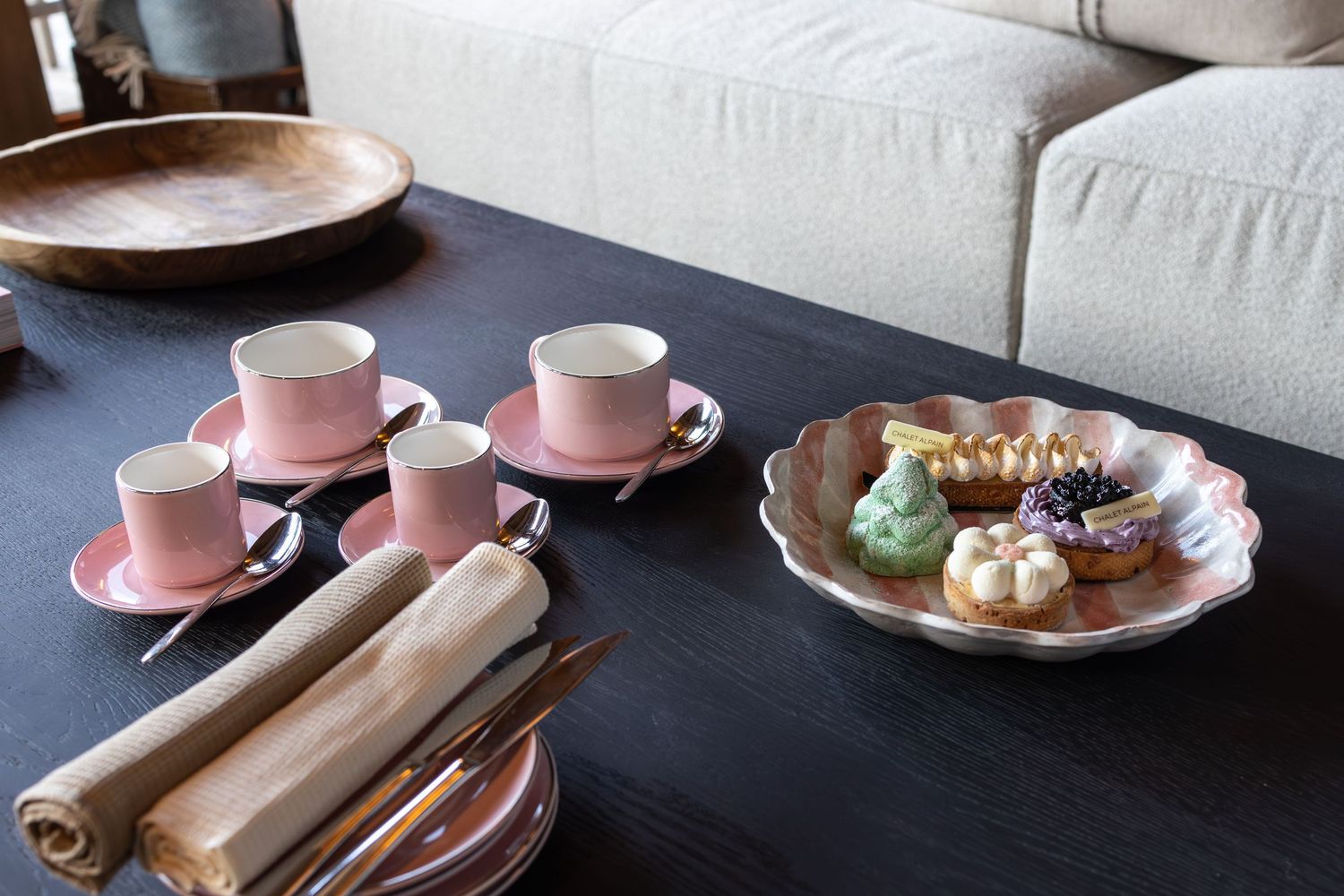pink tea set on coffee table with elegant patisserie cakes