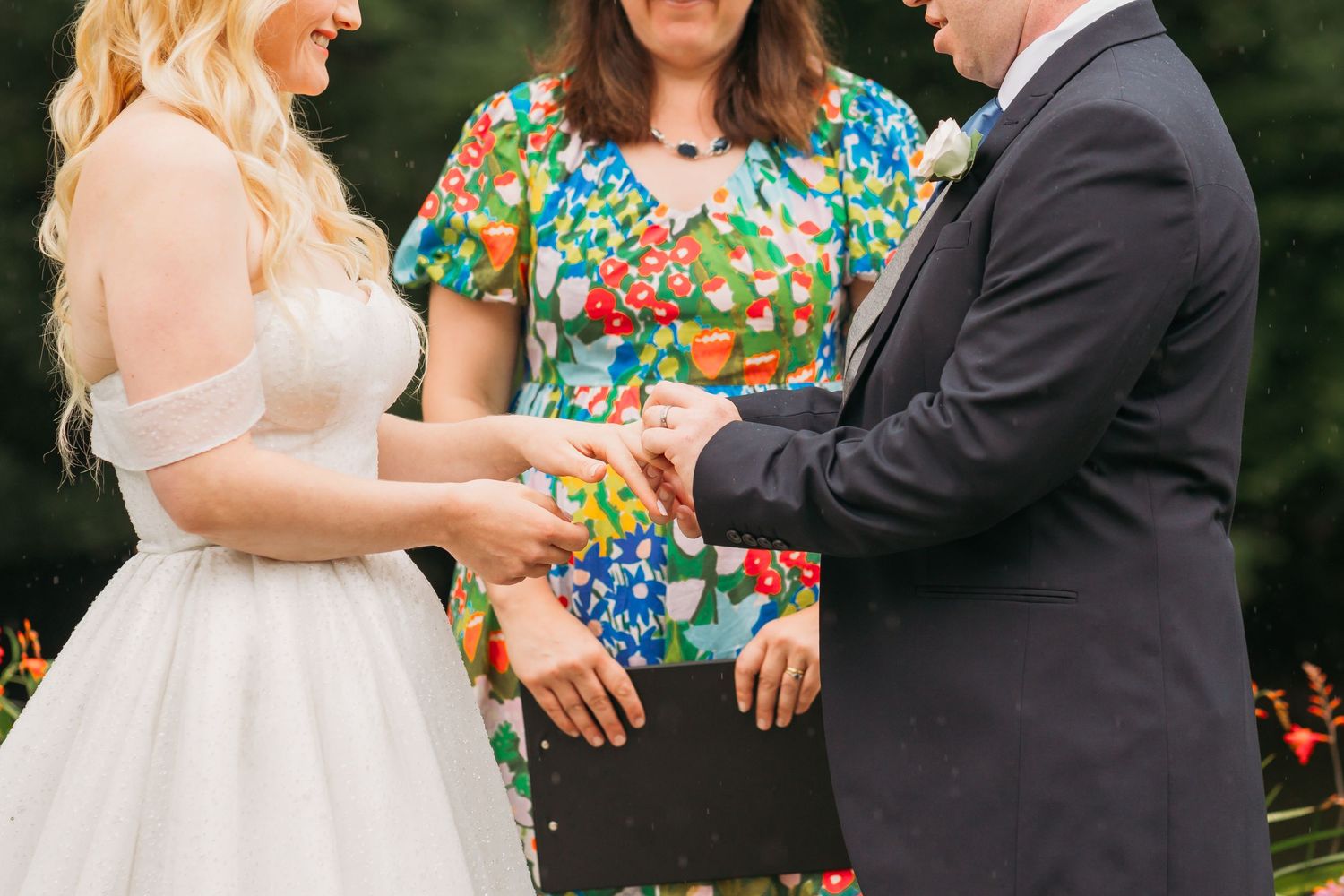 bride and groom exchanging rings at alter in garden wedding
