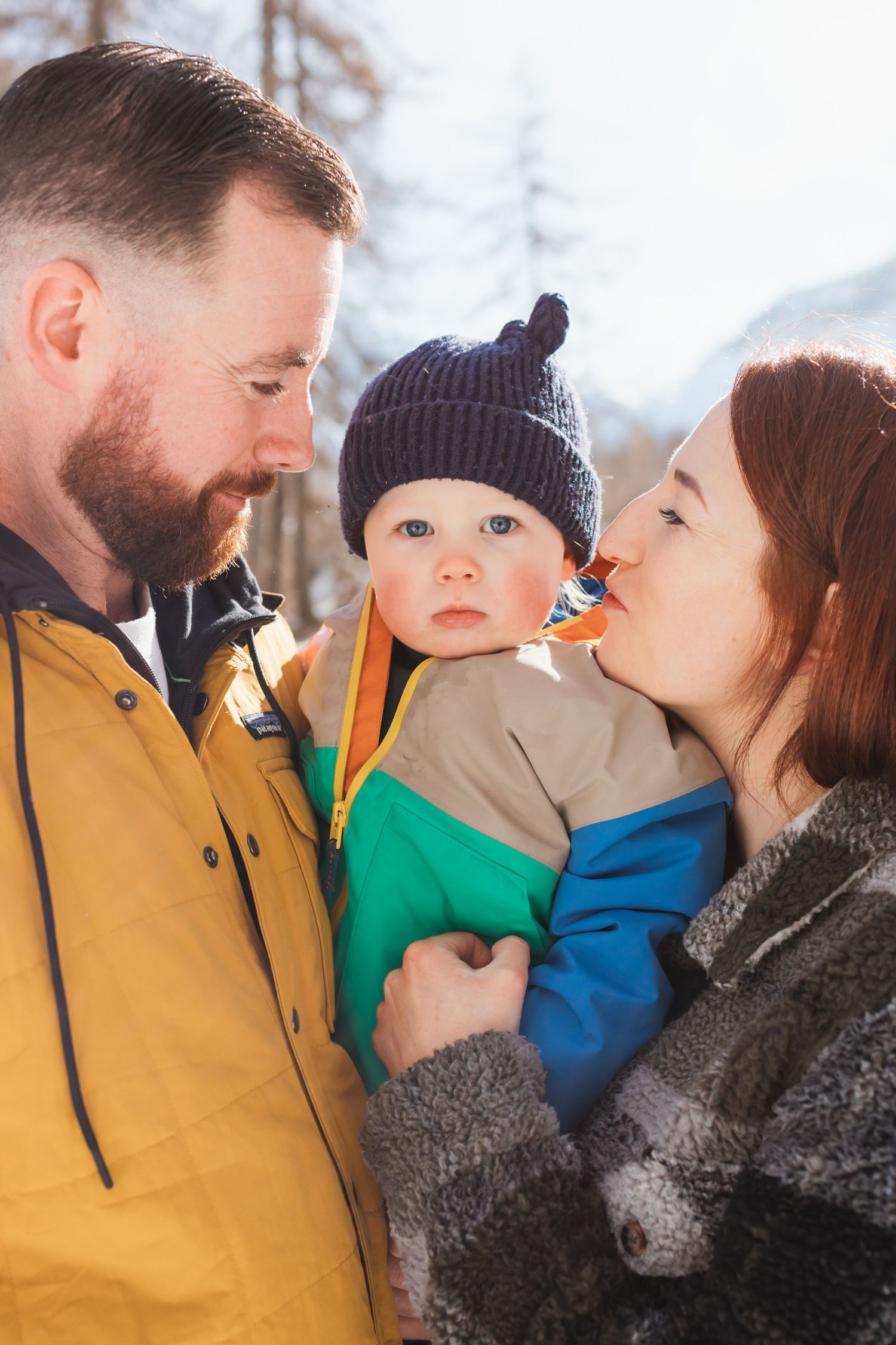 parents look at toddler son affectionatly
