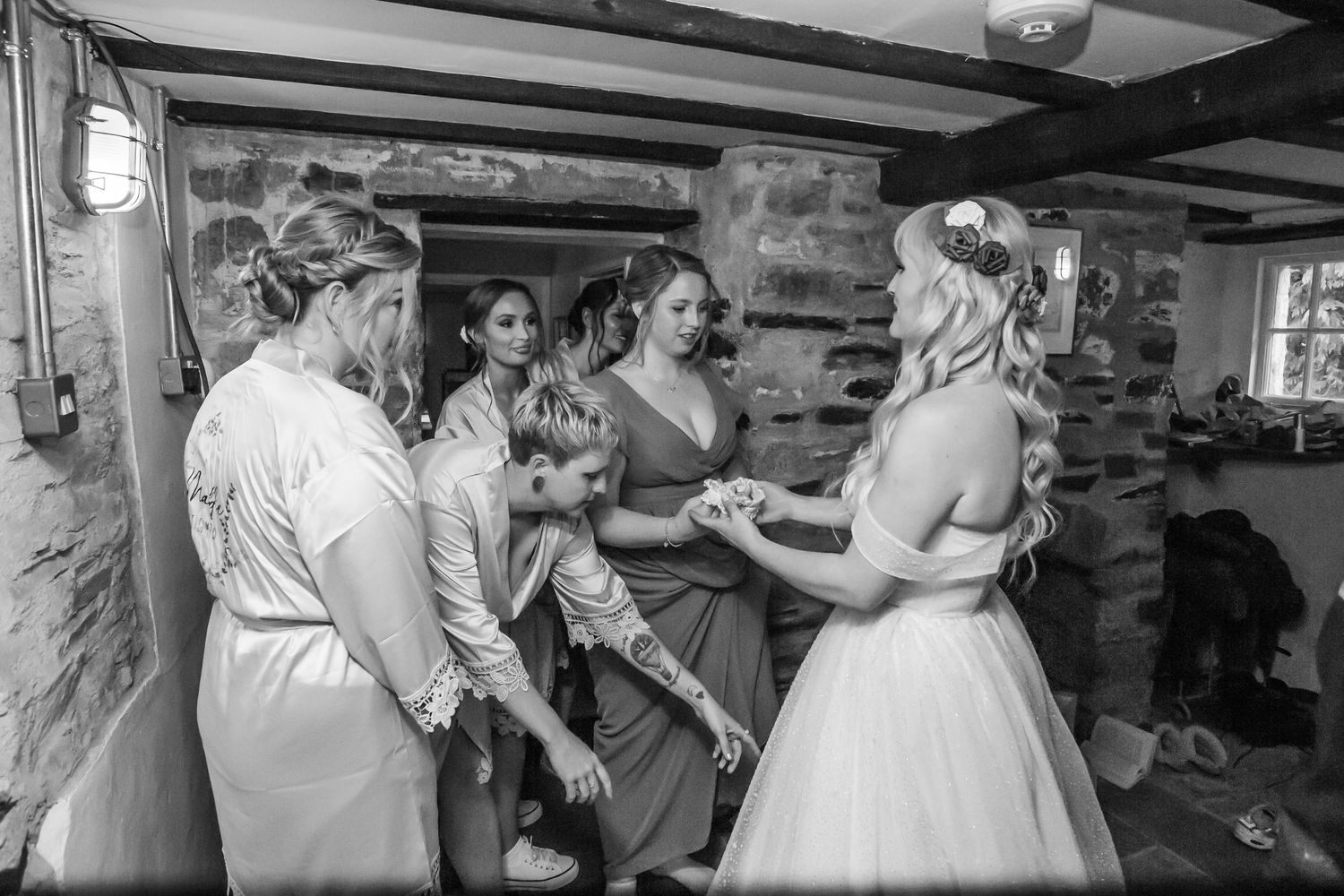 bride greets her bridal group after putting on dress