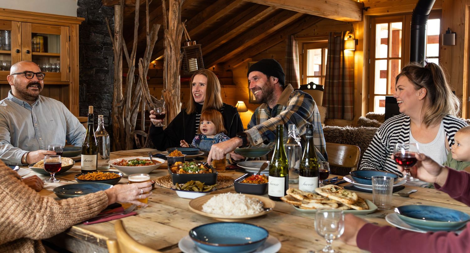 group of people enjoying dinner in rustic ski chalet