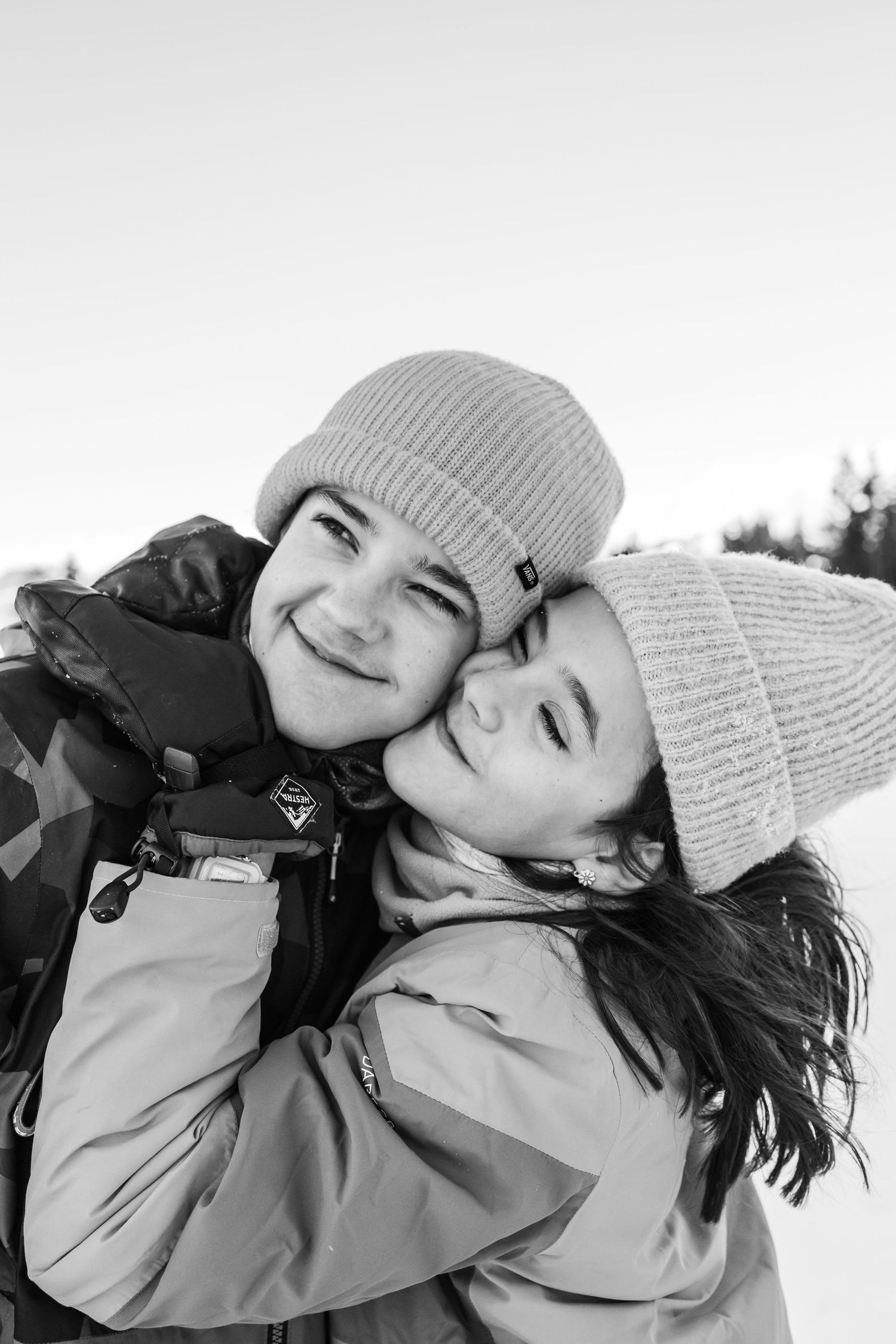 siblings embrace cheek to cheek