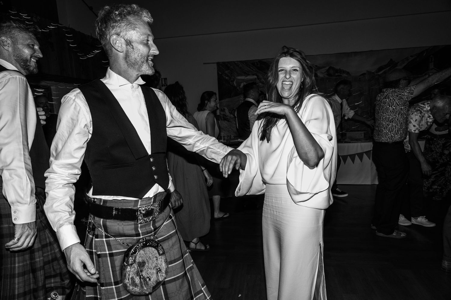 bride laughing after dancing with new husband during wedding