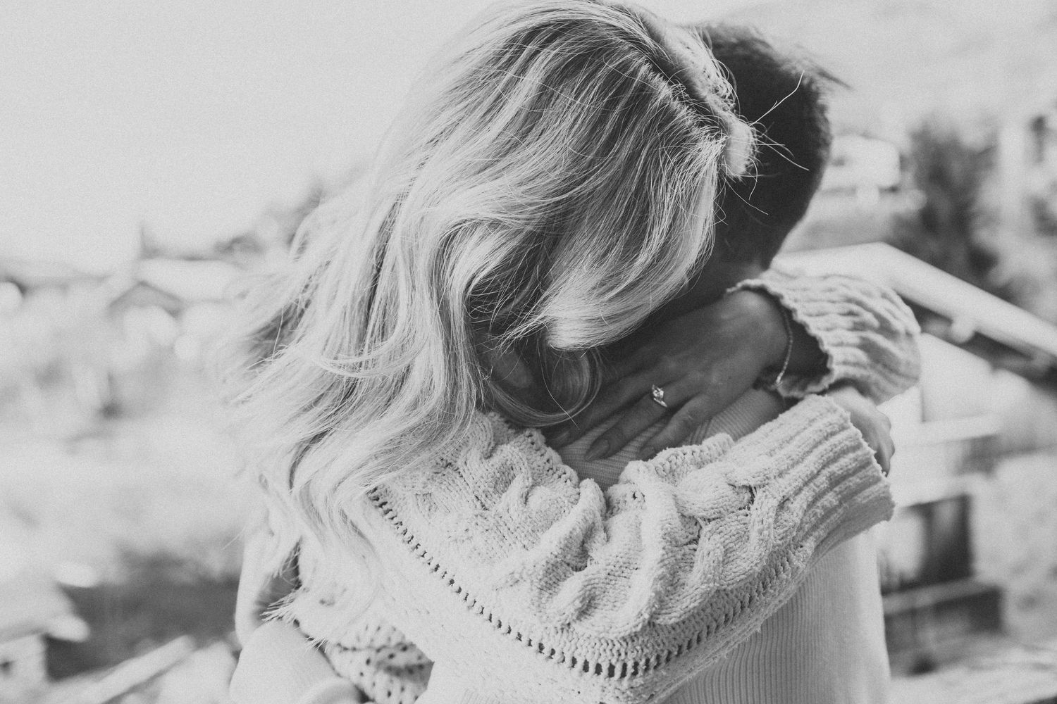 woman hugs man and hair falls forward concealing face