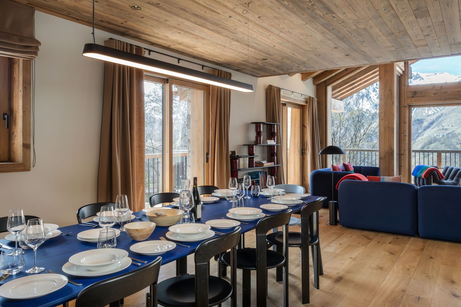 large black dining table laid for dinner in ski chalet