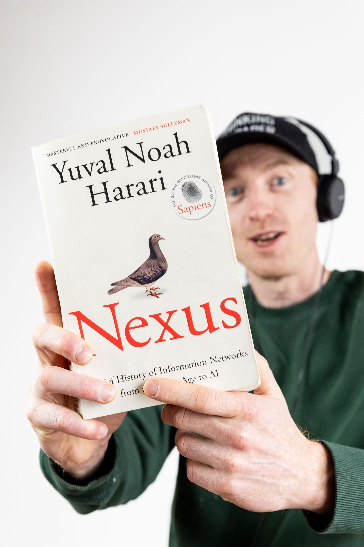podcaster holding up white book
