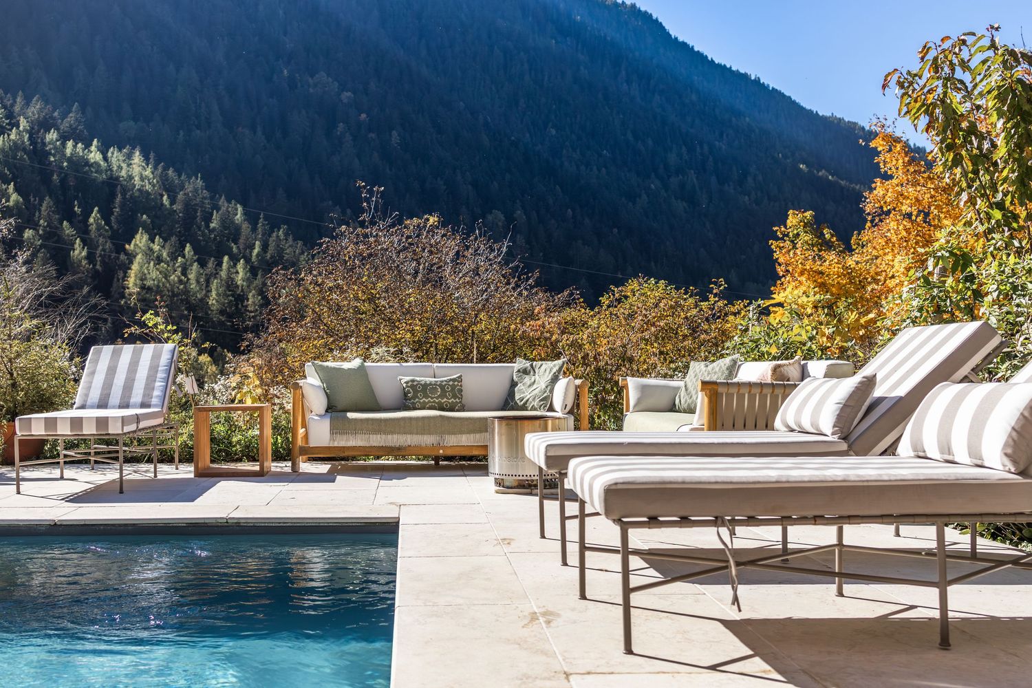 outdoor pool and luxury sun loungers on sunny day in the French alps
