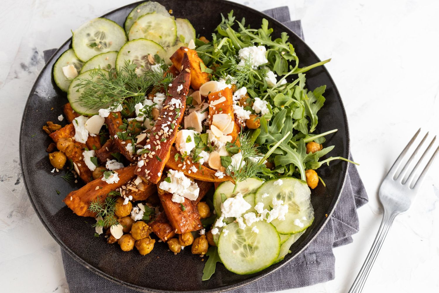large plate of sweet potato and chickpea salad with fork and napkin