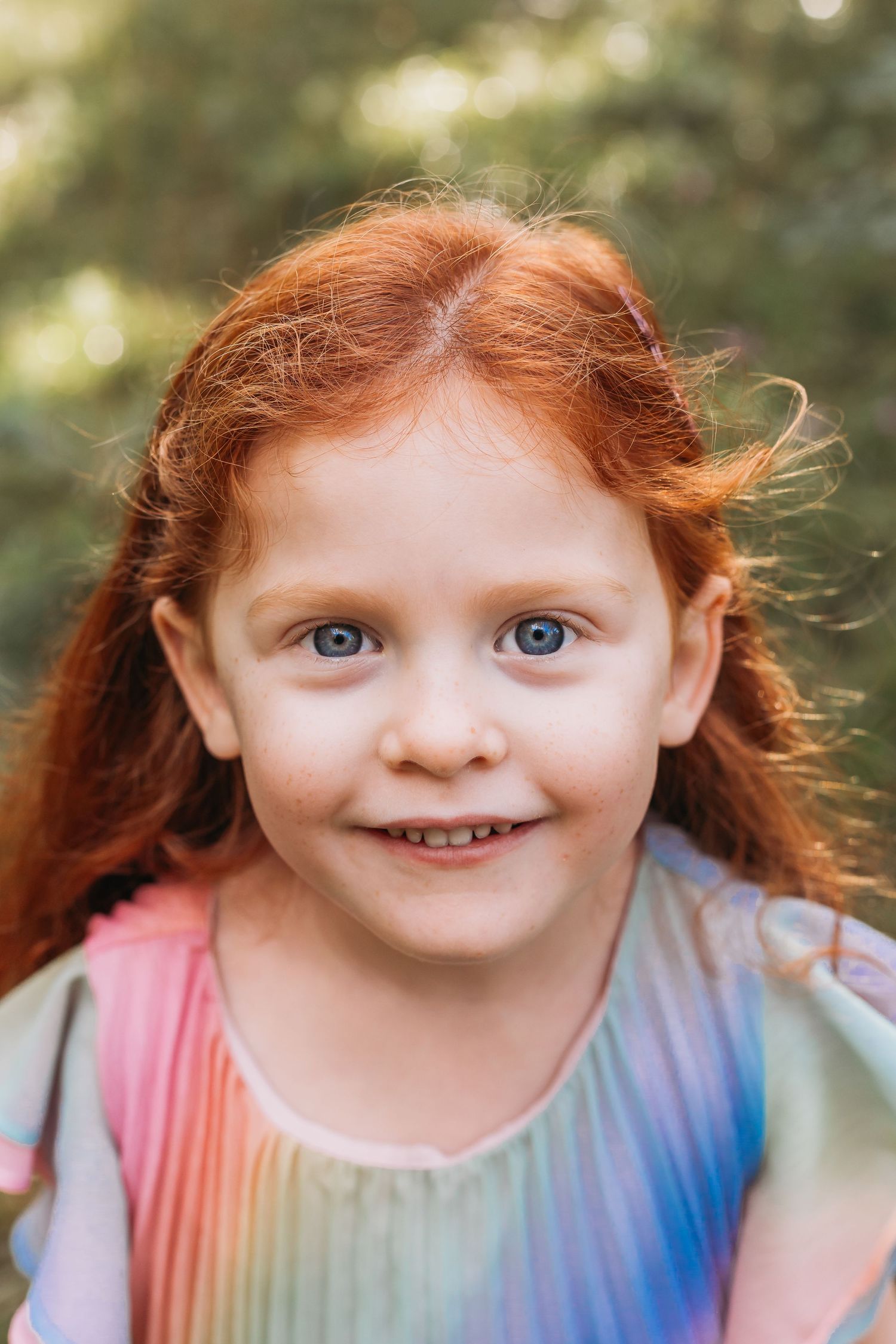 portrait of 4 year old with bright blue eyes