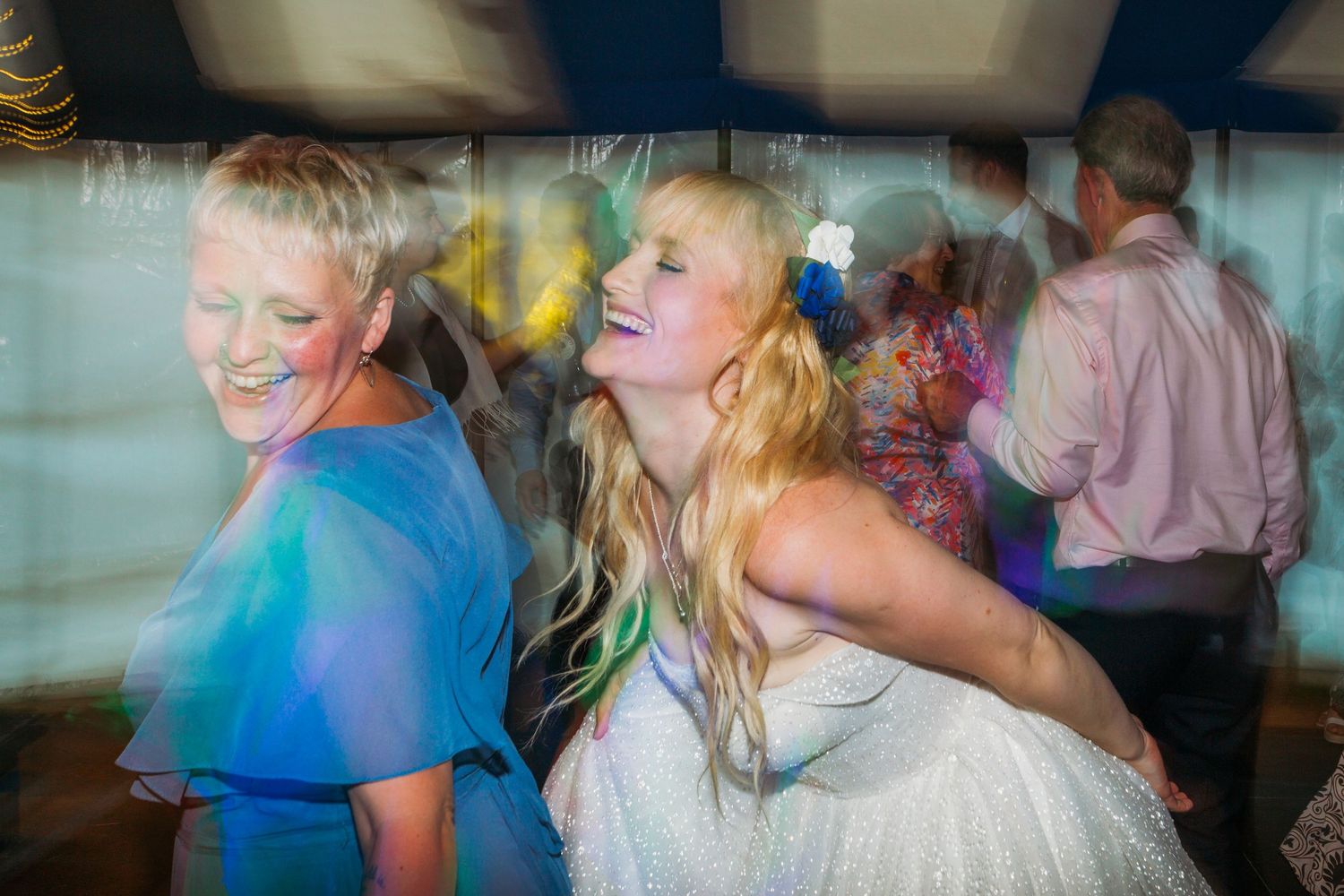 bride dancing with bridesmaid at wedding reception