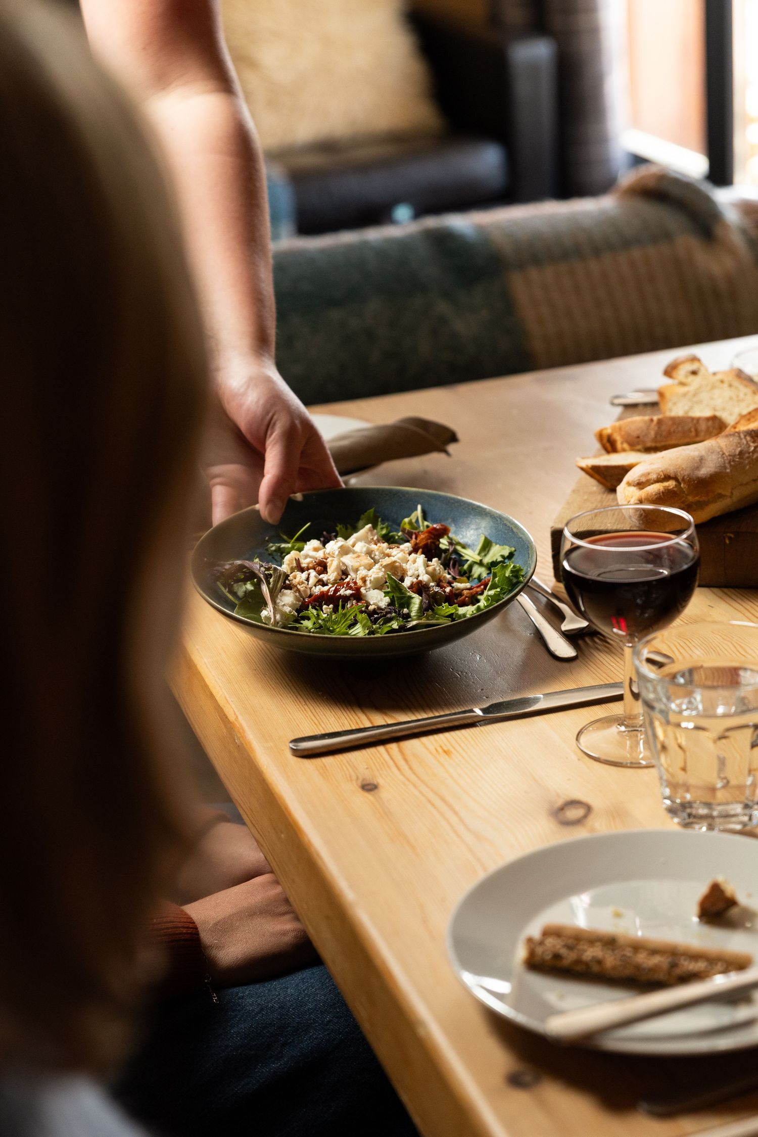 ski chalet host serving guest their evening mean during ski holiday