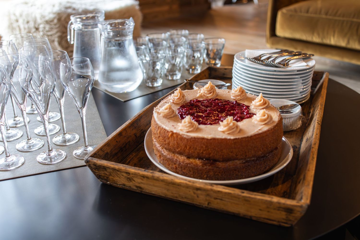 strawberry cake set out with plates and glassware ready for ski holiday guest arrival