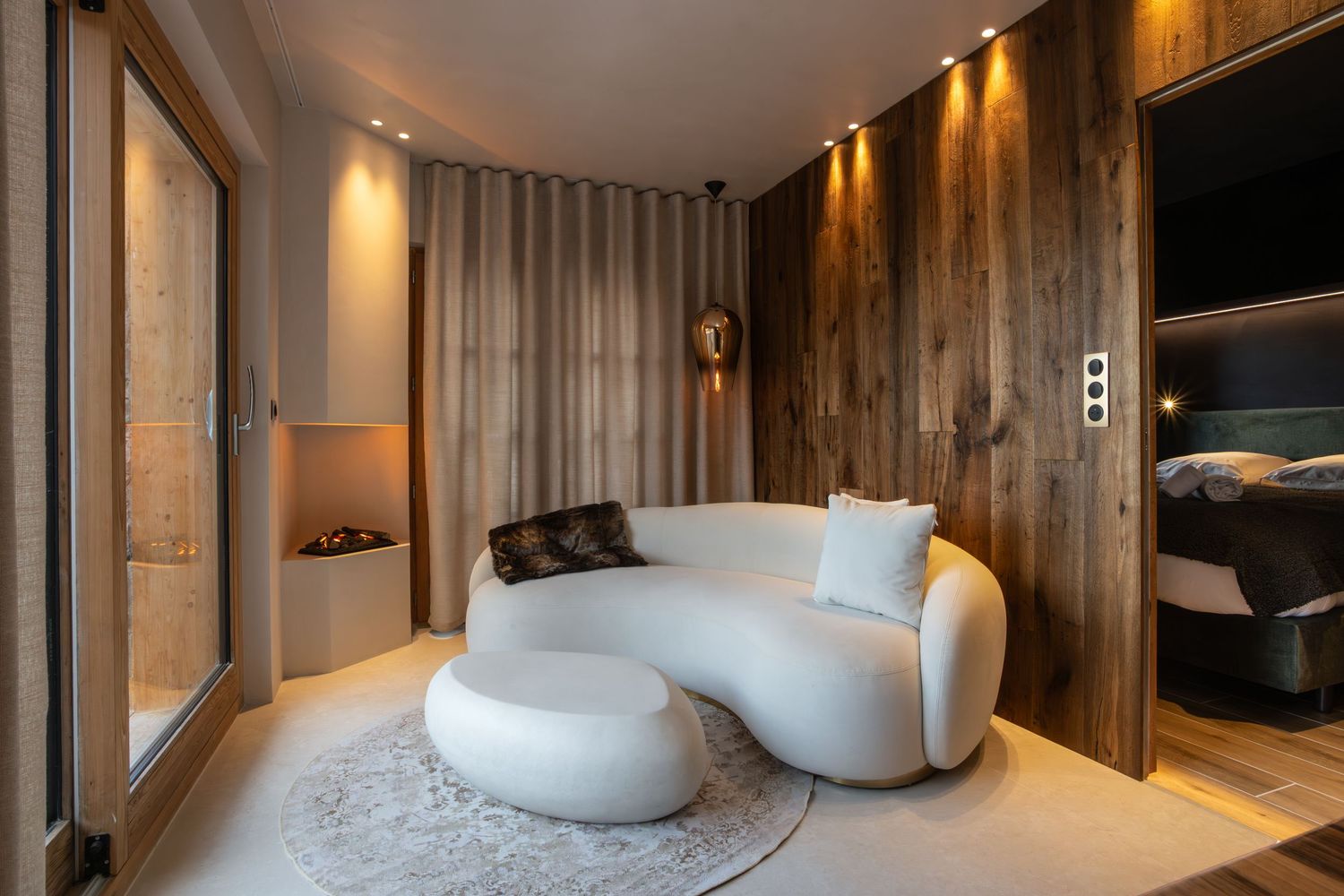 contemporary white sofa sits at end of wooden living space in French alps