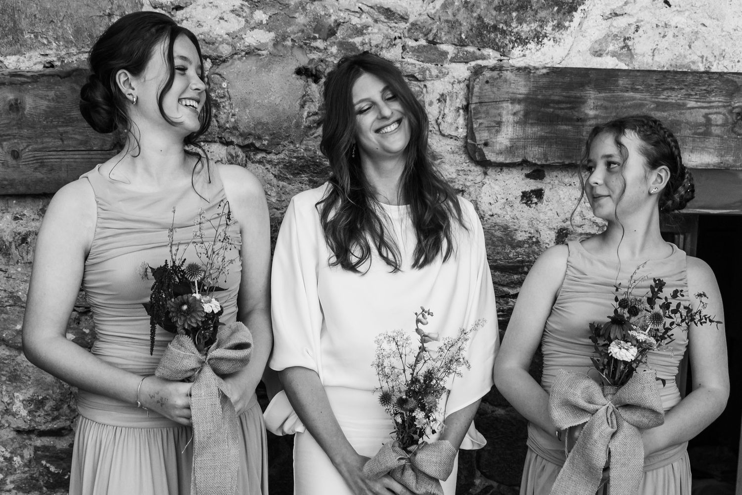bride and two bridesmaids holding bouquets