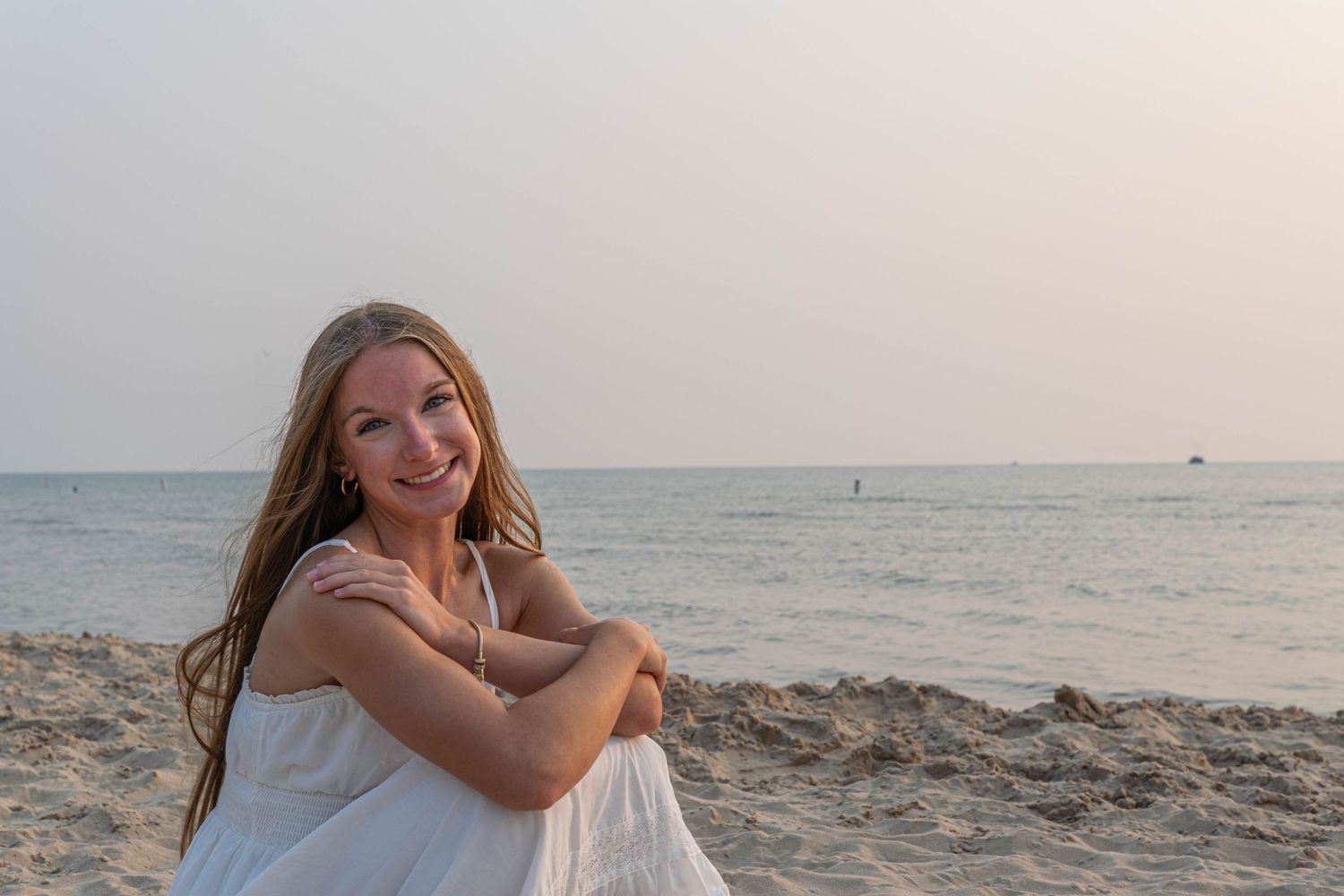 Beachside portrait during golden hour with ocean horizon in background.