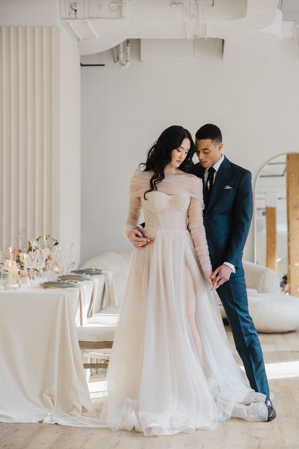 Bride and groom in an intimate moment, holding hands in reception room at Archive Studio. Captured by a Toronto wedding 