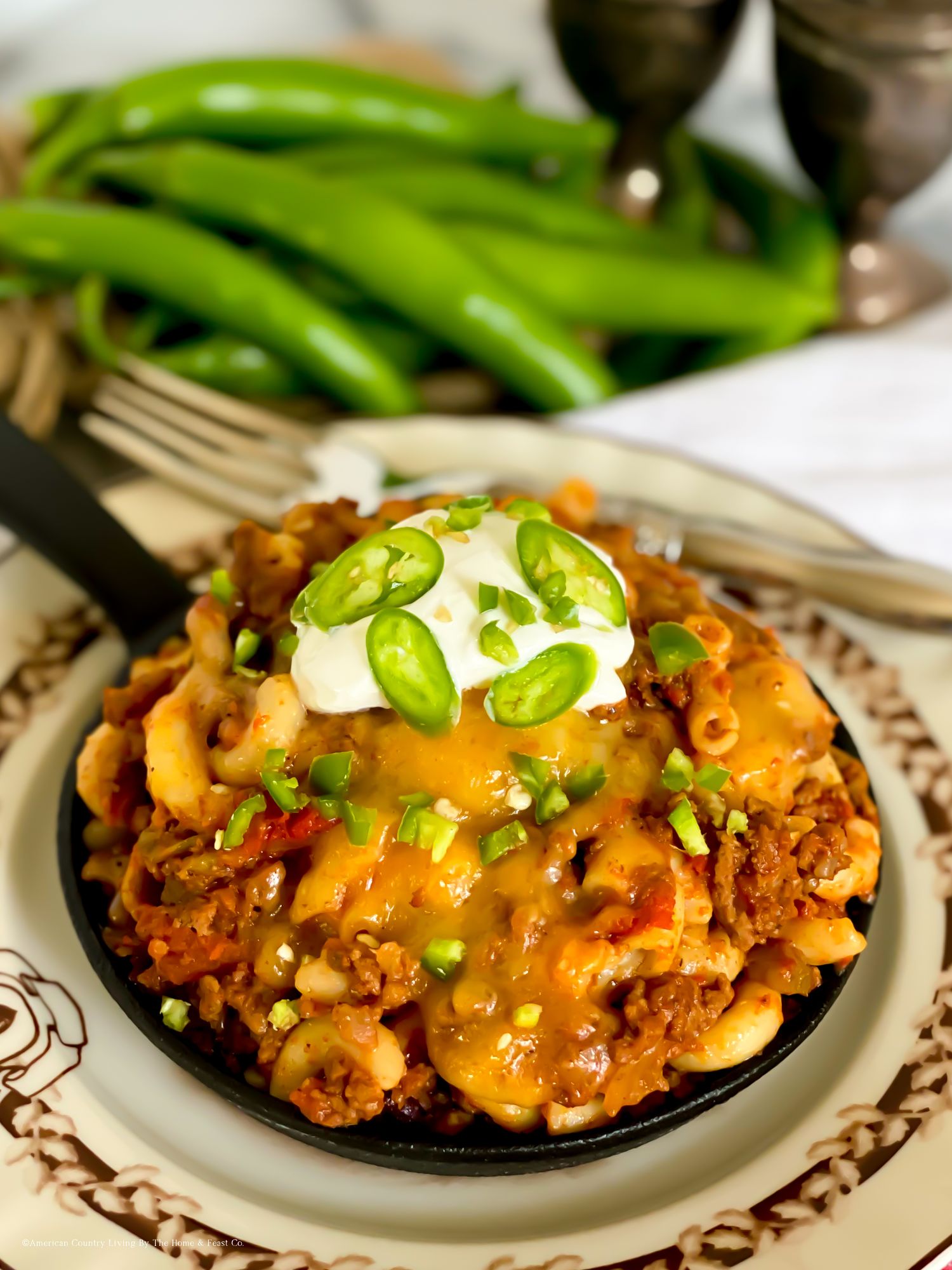 Mexican-inspired pasta dish garnished with jalapenos, sour cream and cheese served with green chiles.