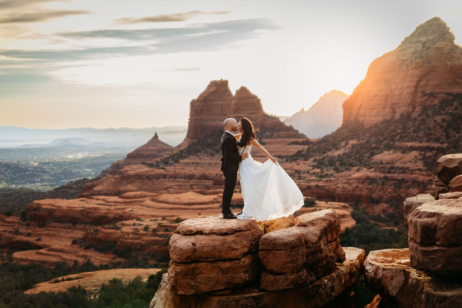 Wedding couple kissing at merry go round rock in Sedona AZ