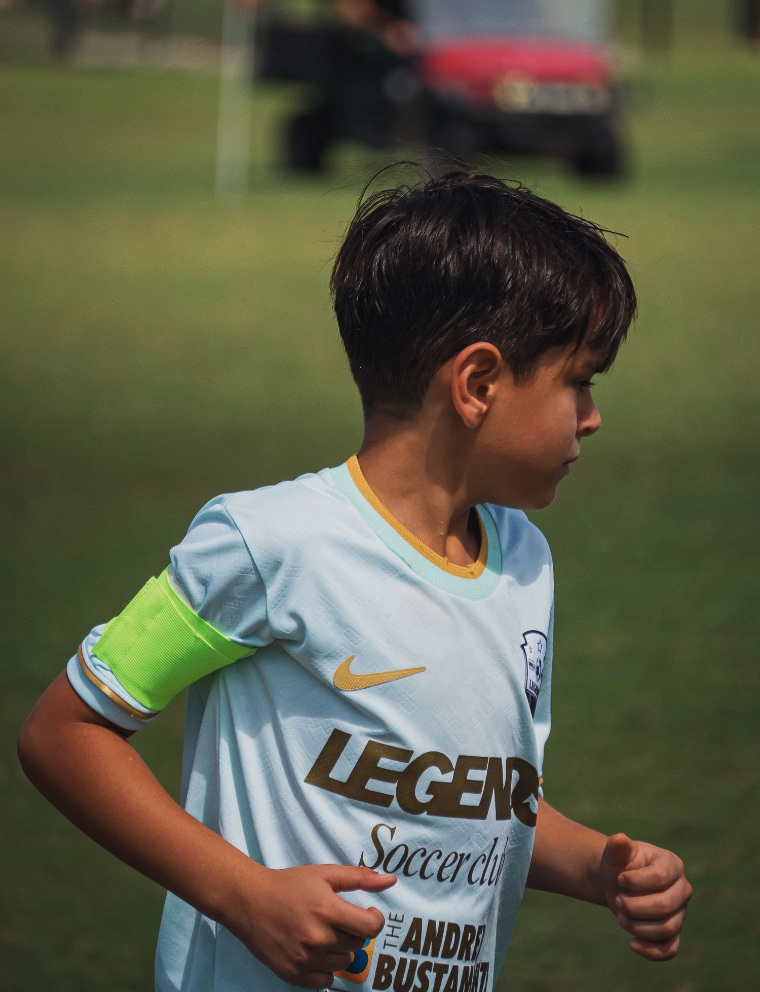 Young boy in light blue Legends Soccerlife Nike jersey runs during youth soccer game.