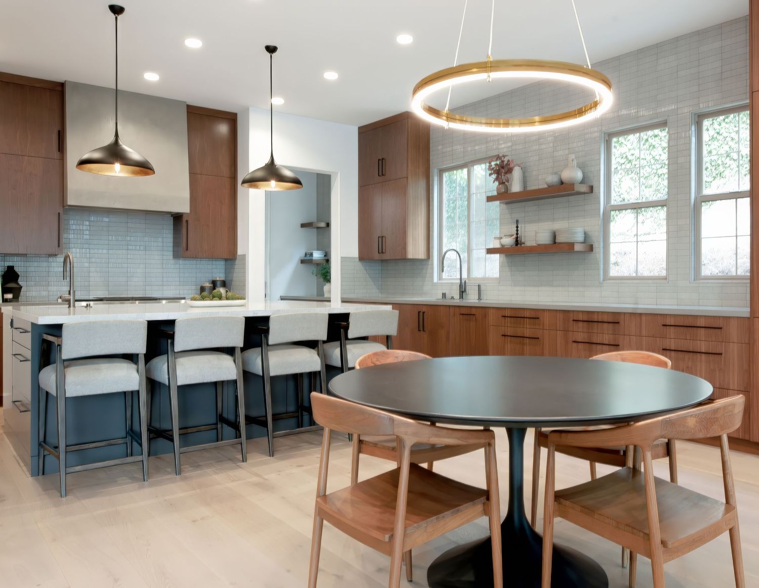 Contemporary dining area with circular pendant light, wooden furniture, and open concept layout. Interior Designed Kitchen shot