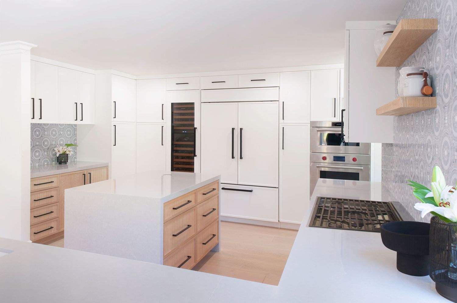 Contemporary white kitchen with sleek cabinets and wooden accents in a minimalist style designed by an interior designer in orange county CA