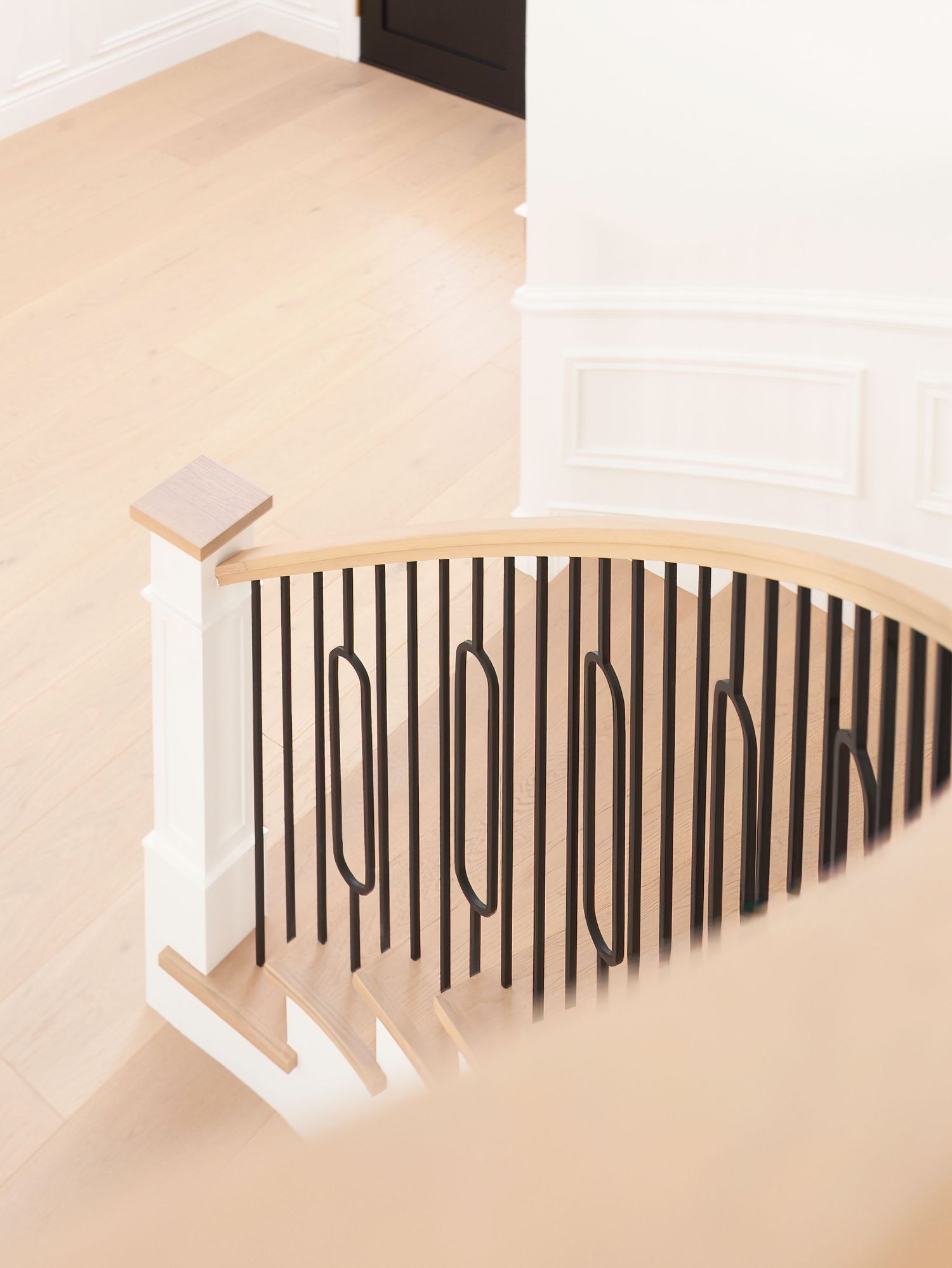 Photo of remodeled modern stair case with black geometric railing shot by an ornge county CA fine art photographer.