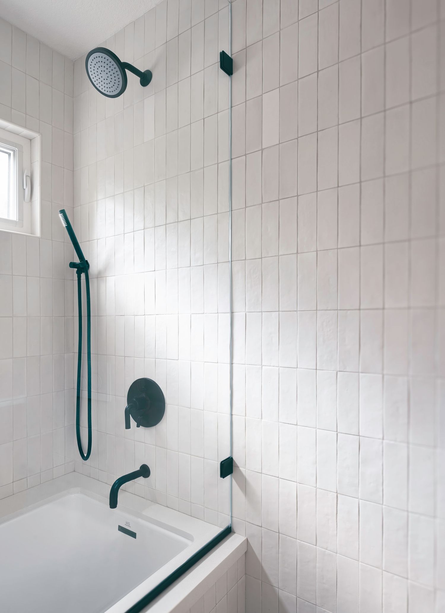 Architectural photograph of minimalist white tiled shower with black fixtures in orange county California