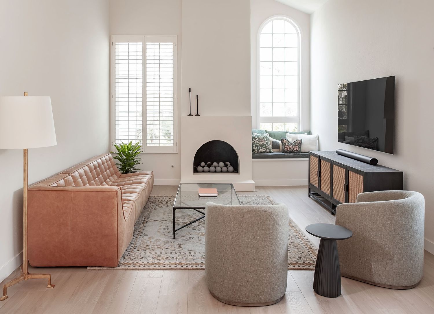Light-filled modern living room with a soft neutral palette and fireplace, photographed by an Orange County interior photographer.