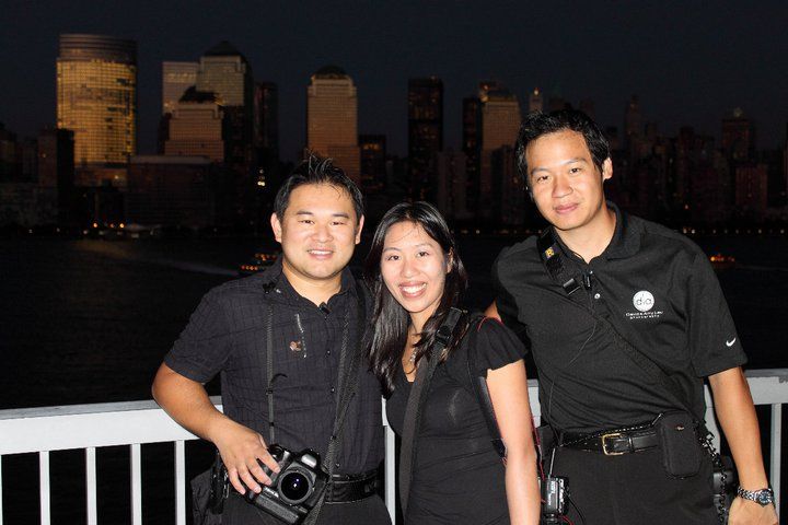 Group photo at night with city skyline visible in the background.