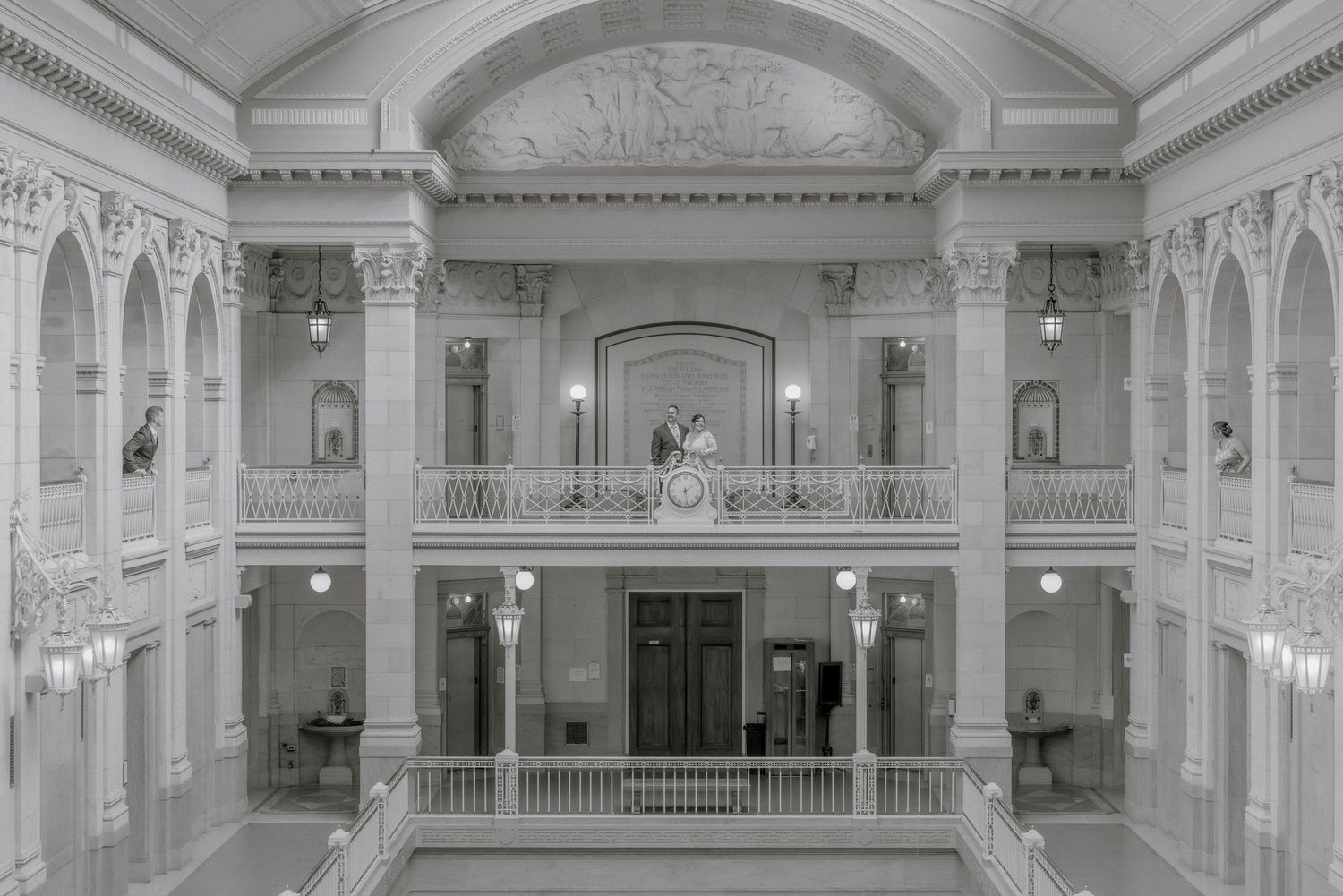 Elegant classical interior architecture with white columns and balconies in a historic building.