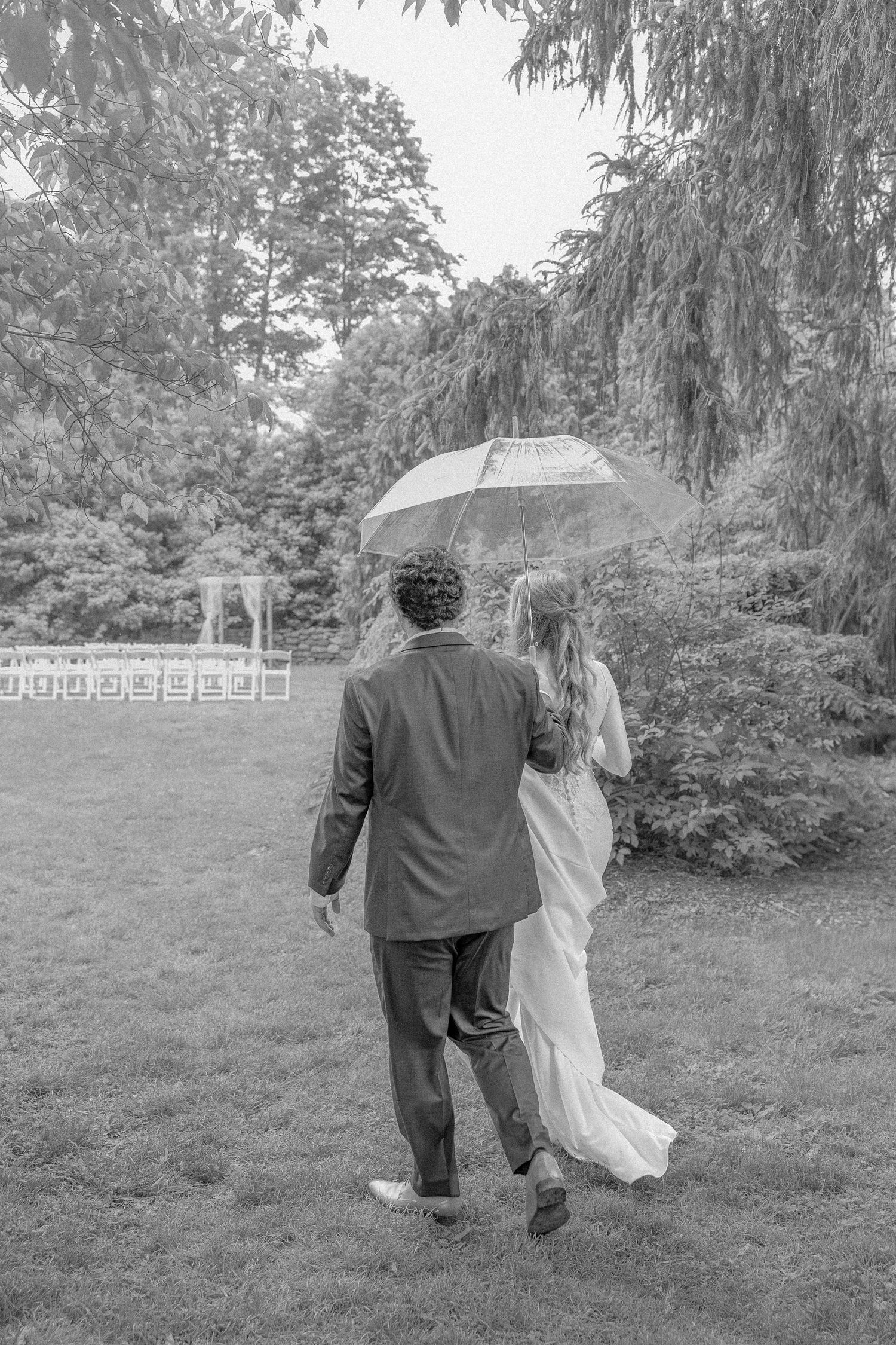 A black and white photo sequence shows two people walking together through a grassy area under tall trees.