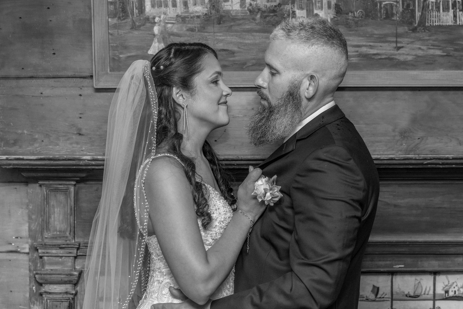 A couple shares an intimate moment during their black and white wedding portrait session.