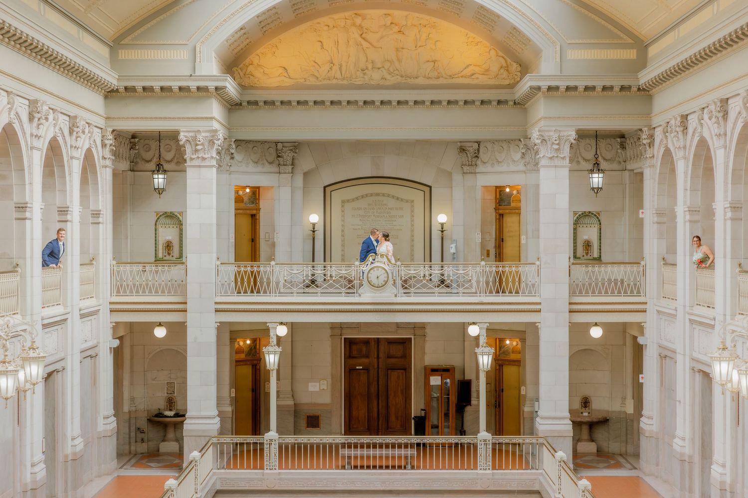 Architectural view of elegant marble interior with balconies and skylight in historic building.