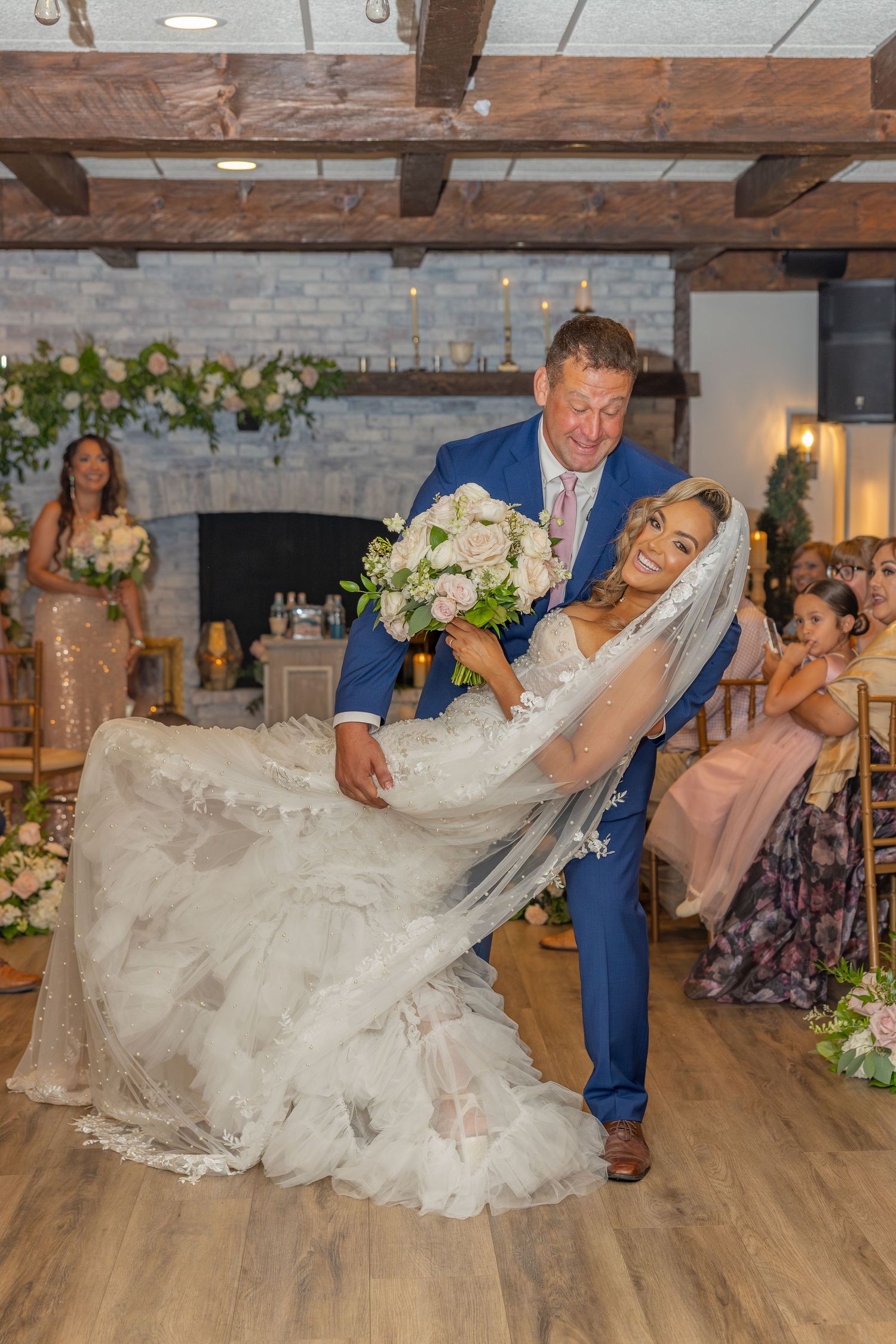 Newlyweds sharing a playful dip on the dance floor at their wedding reception.