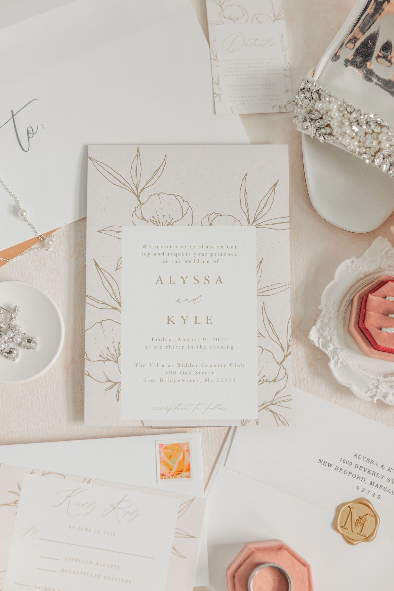 Elegant wedding invitation with minimalist floral design and gold accents.