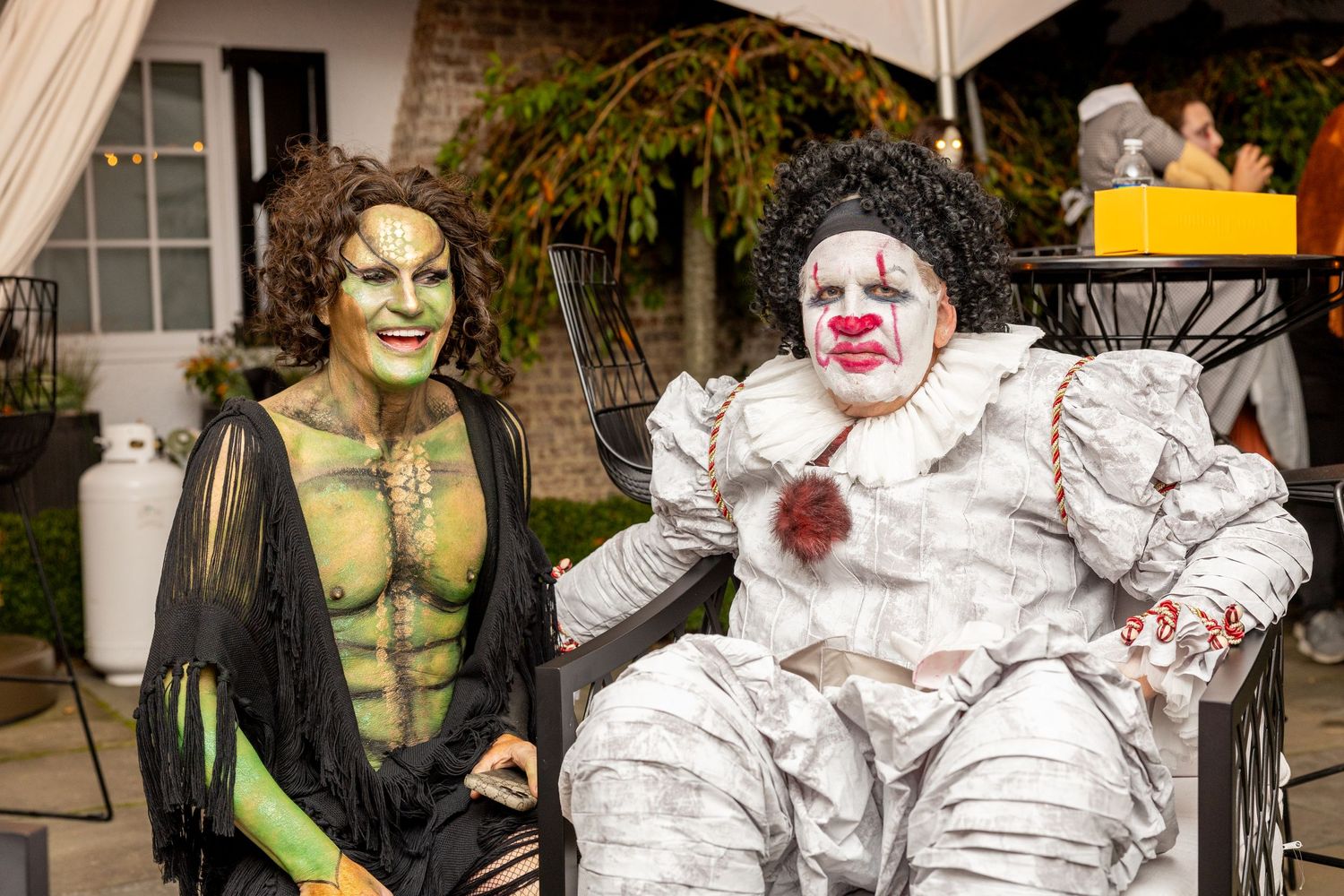 Halloween costumes including a muscular green character and a spooky white clown at a party.