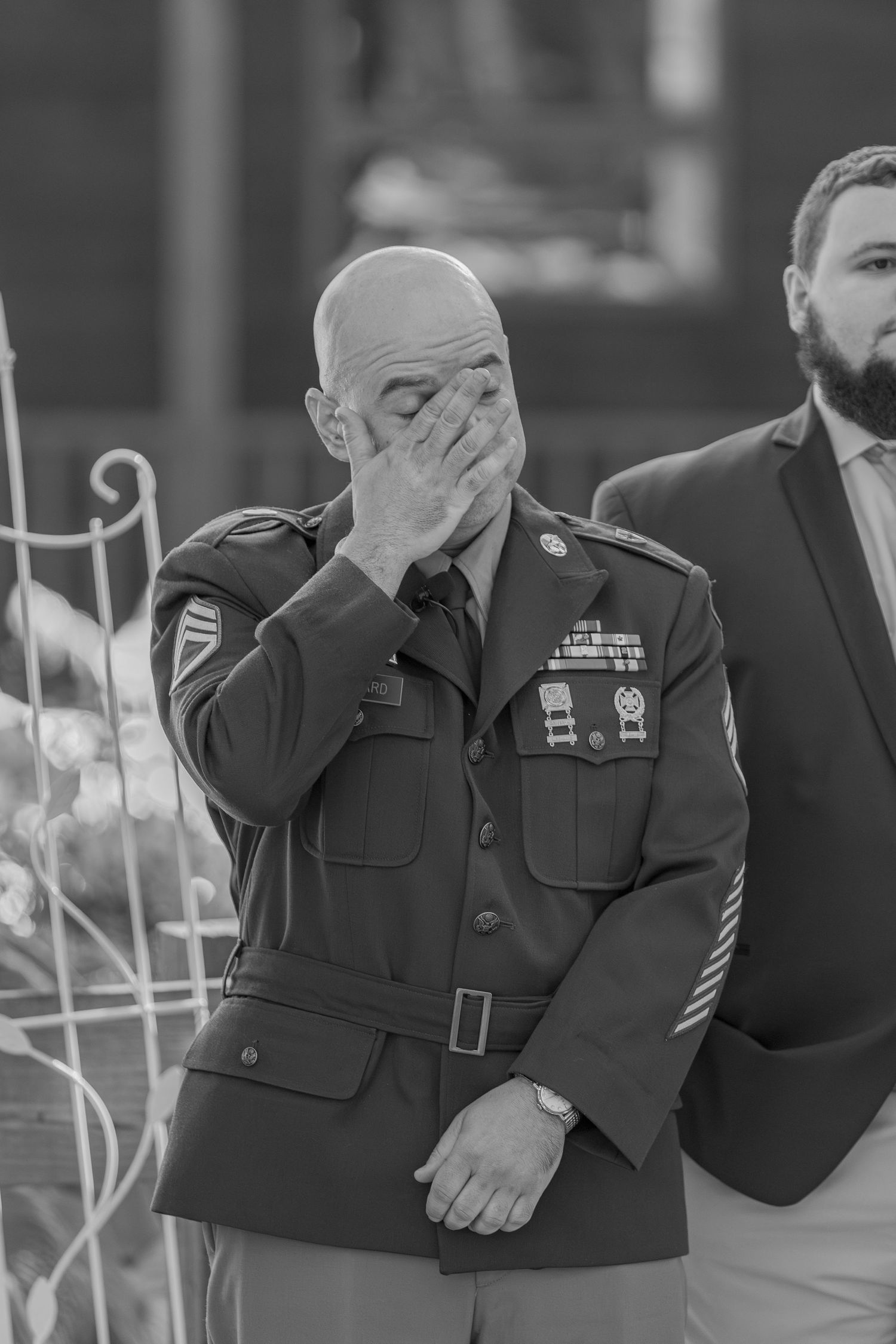Military servicemember displays emotional reaction during formal ceremony.