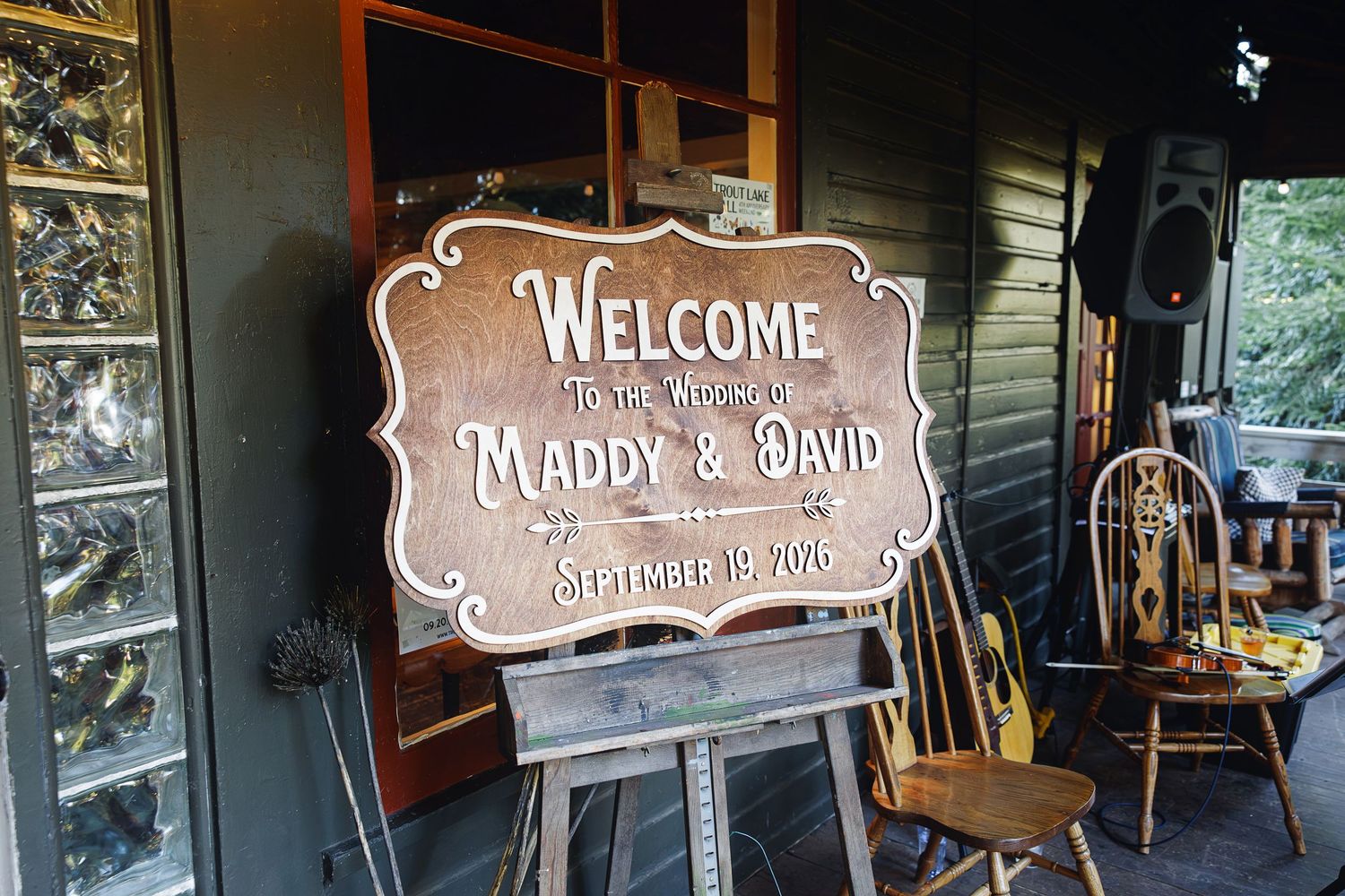 Rustic wooden welcome sign for Maddy & David wedding on September 19, 2020, displayed on an easel outdoors.
