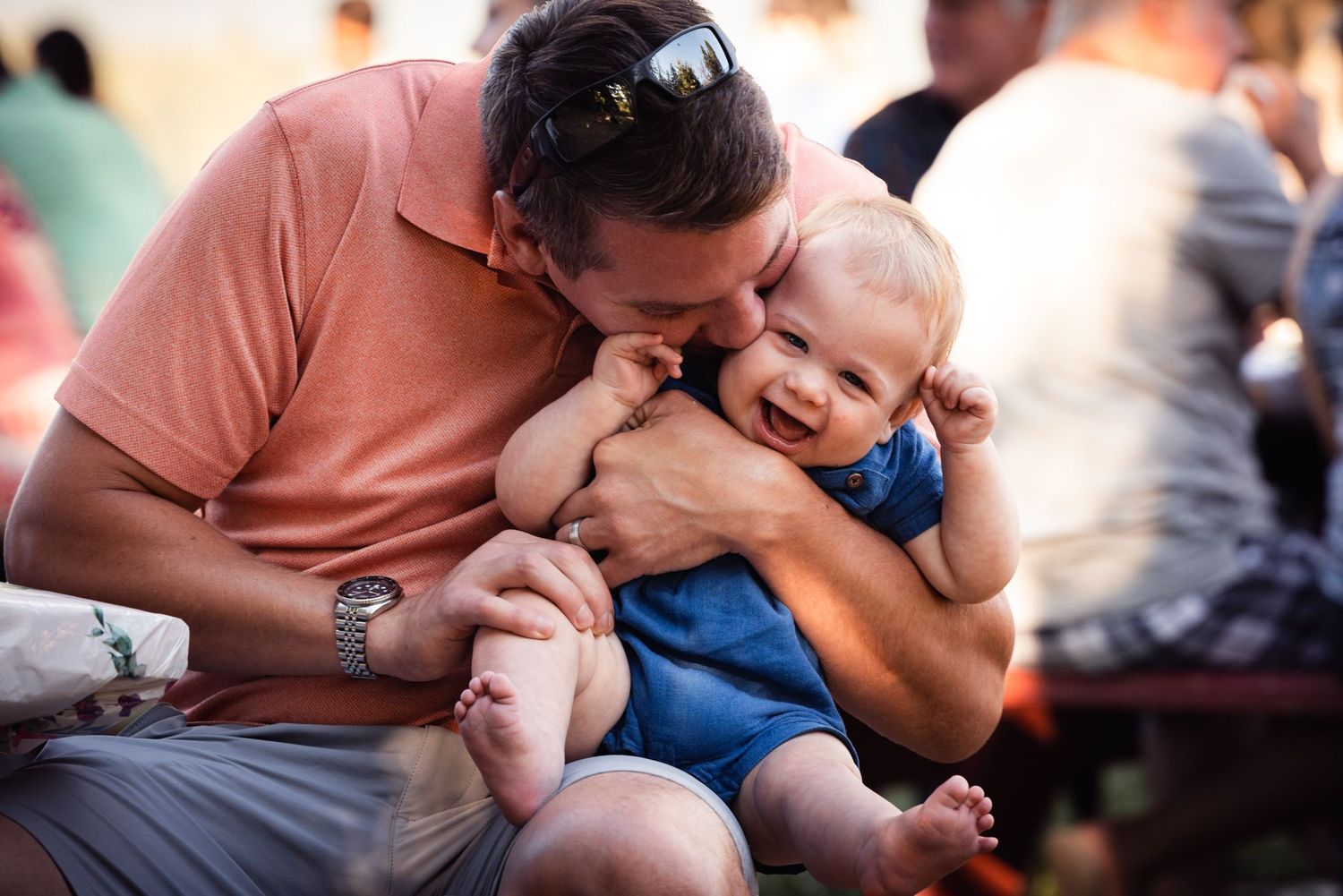 A touching candid moment of play and connection shared between parent and child on a sunny day.