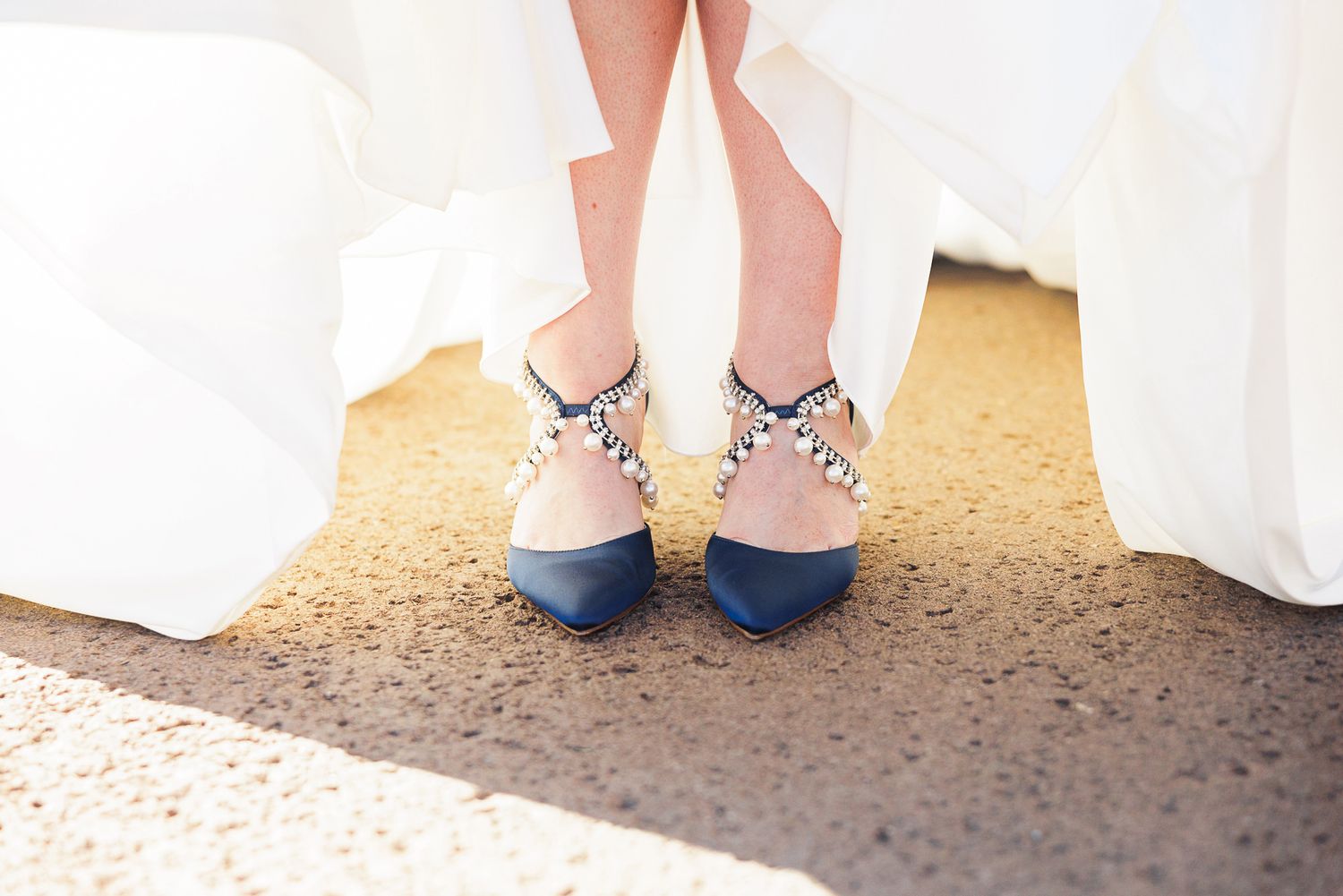 A row of wedding party members showing off their colorful socks and shoes beneath formal attire.