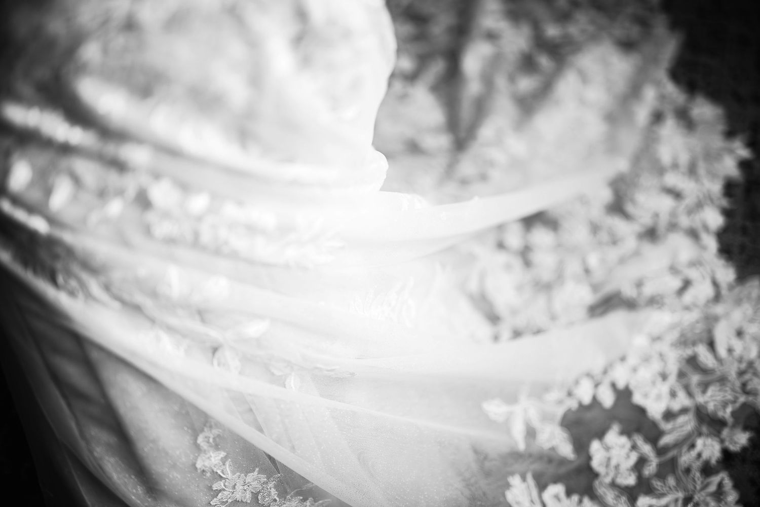 A grainy black and white photograph showing abstract flowing lines and textures in a dreamy, ethereal composition.