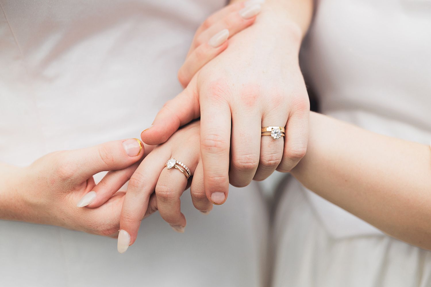Close-up photo series showing hands wearing engagement rings from different angles on white background.