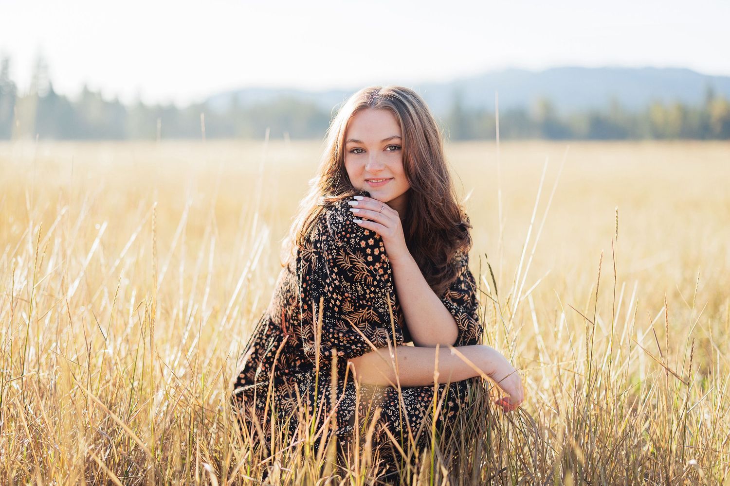 Portrait in golden wheat field wearing leopard print dress at sunset.