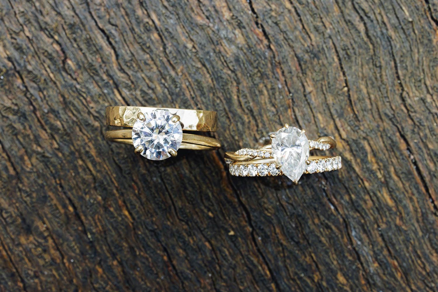 Sparkling diamond engagement ring collection displayed on rustic wooden surface showcasing various solitaire and halo settings.