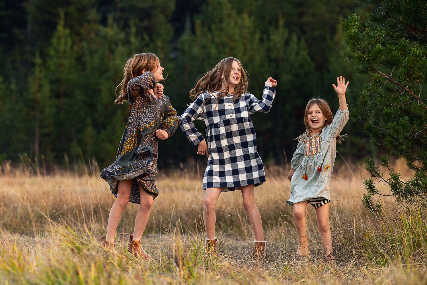 Children's feet splashing and dancing in a field at sunset creating playful silhouettes against golden light.
