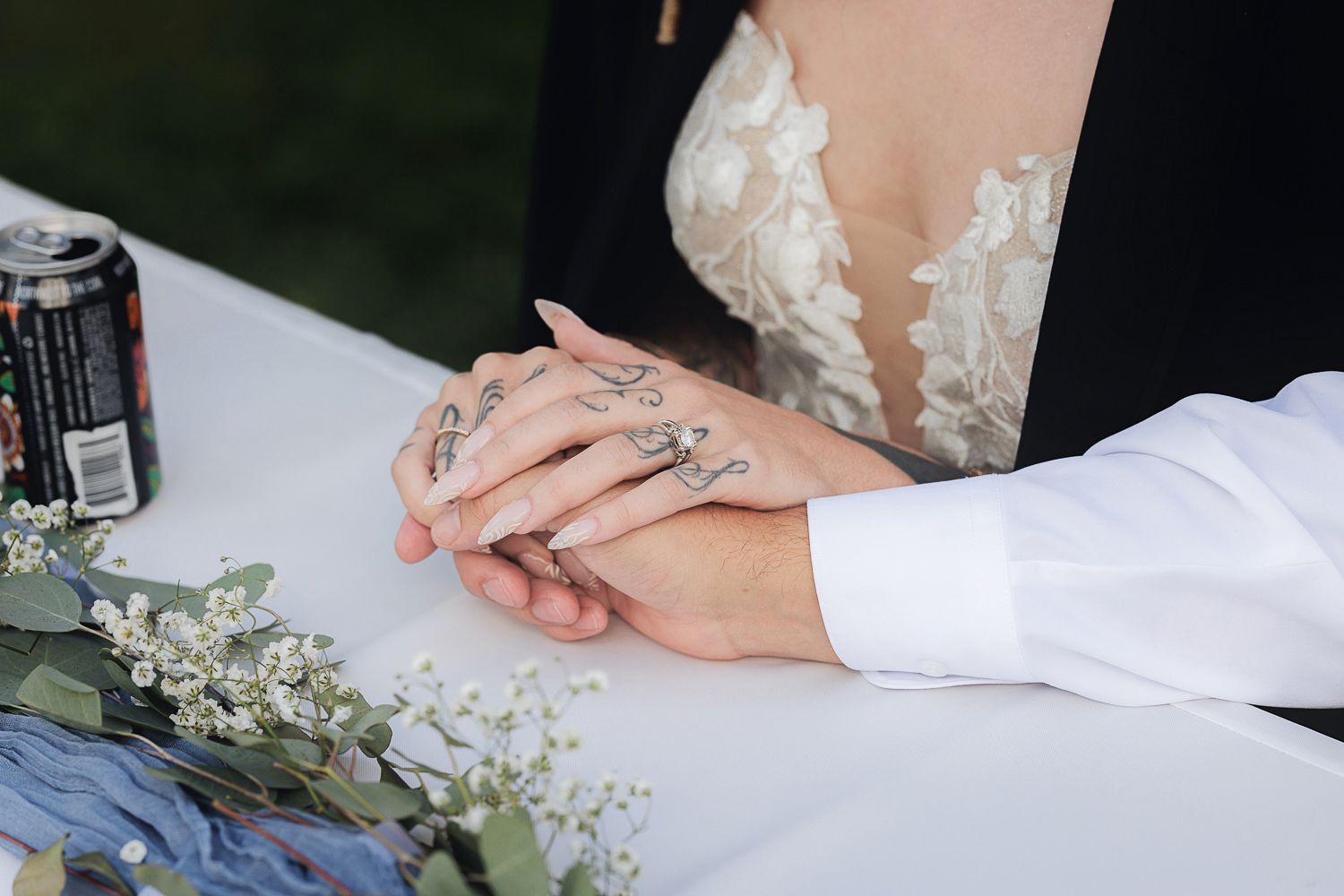 Multiple close-up shots of hands exchanging rings during a wedding ceremony with delicate white floral accents.