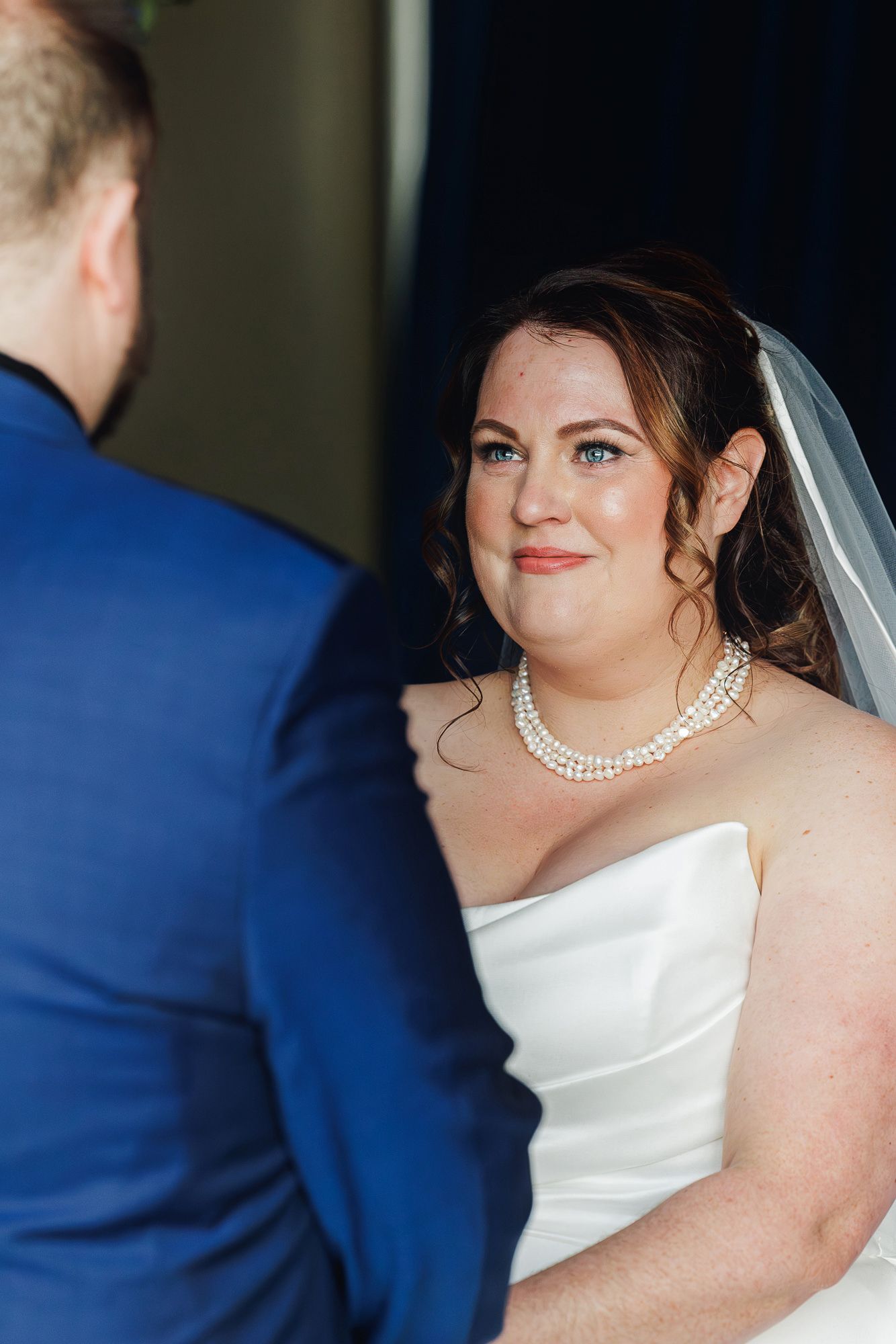 A bride in a white wedding dress with a pearl necklace shown in a series of close-up profile shots.